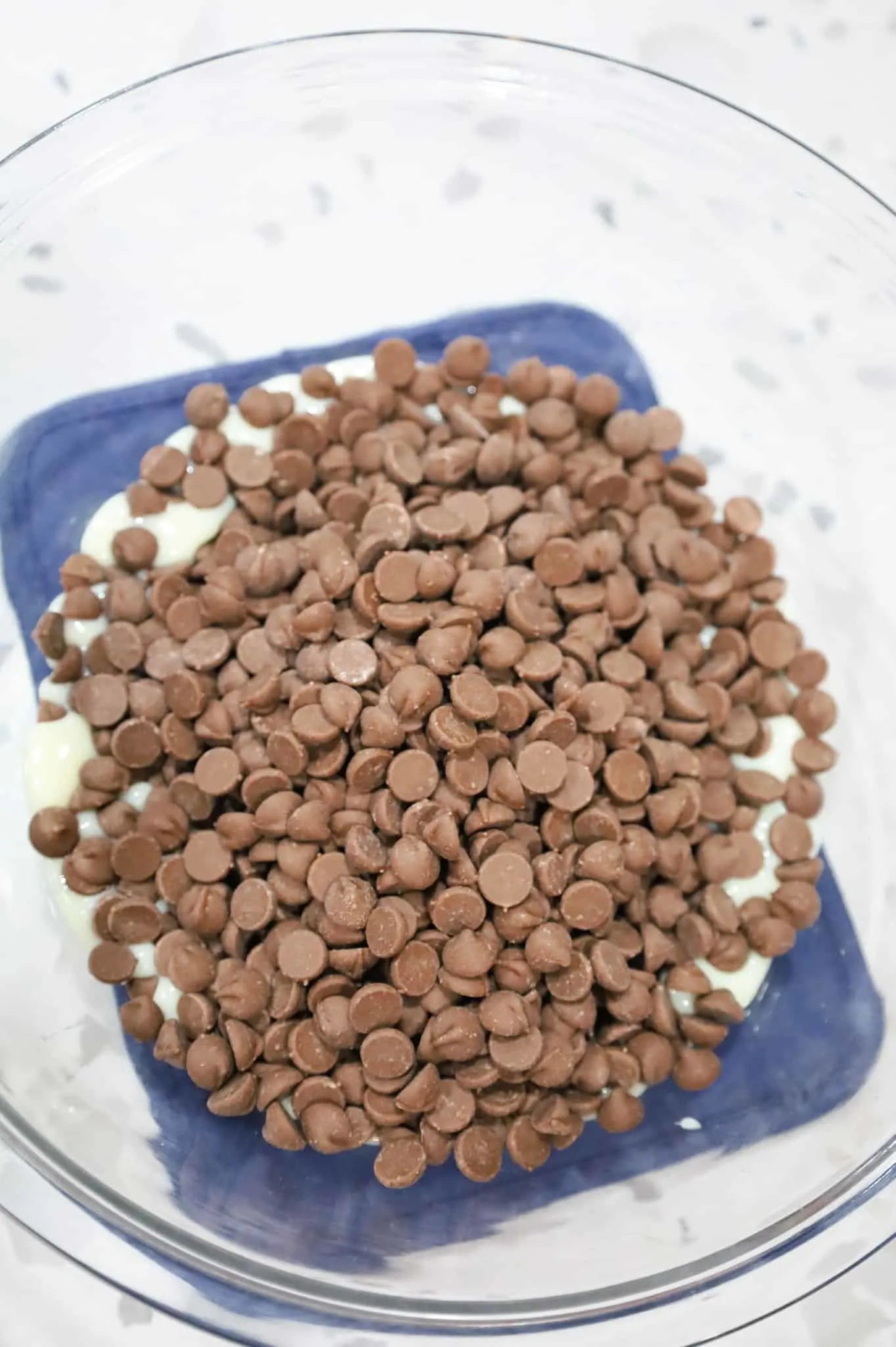 milk chocolate chips and sweetened condensed milk in a bowl