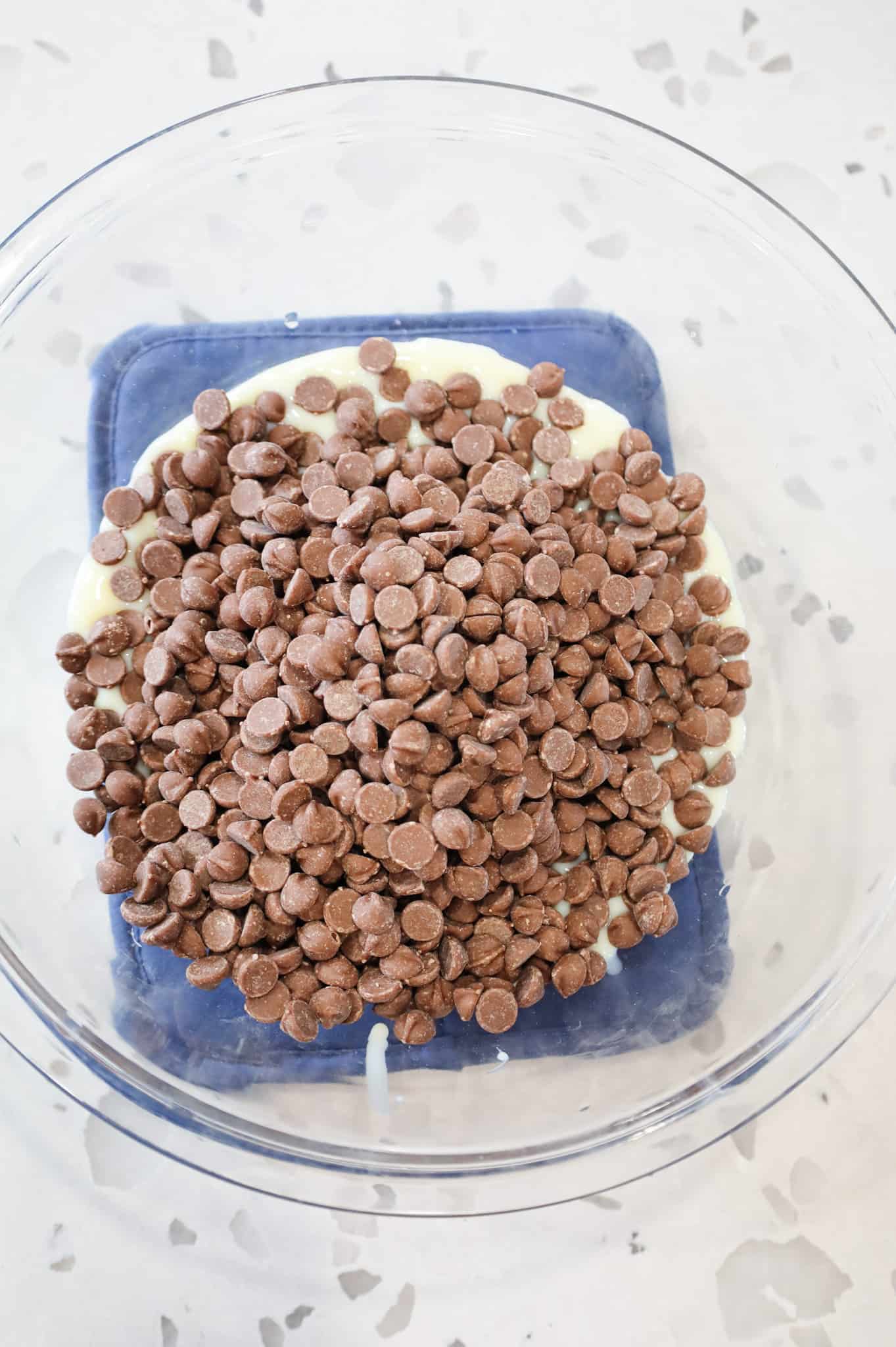 milk chocolate chips and sweetened condensed milk in a bowl