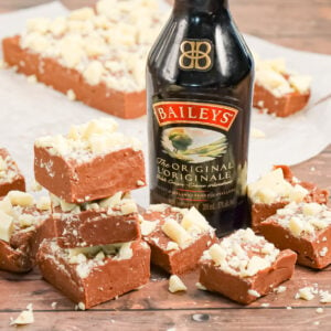 Bailey's Fudge is an easy chocolate fudge recipe made with milk chocolate chips, sweetened condensed milk and Bailey's Irish cream and topped with chopped white chocolate.