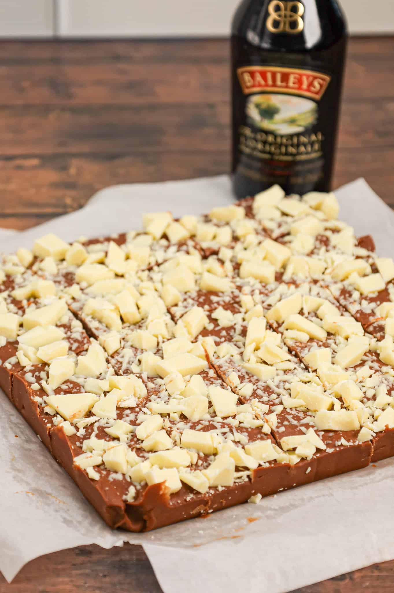 Bailey's Fudge is an easy chocolate fudge recipe made with milk chocolate chips, sweetened condensed milk and Bailey's Irish cream and topped with chopped white chocolate.