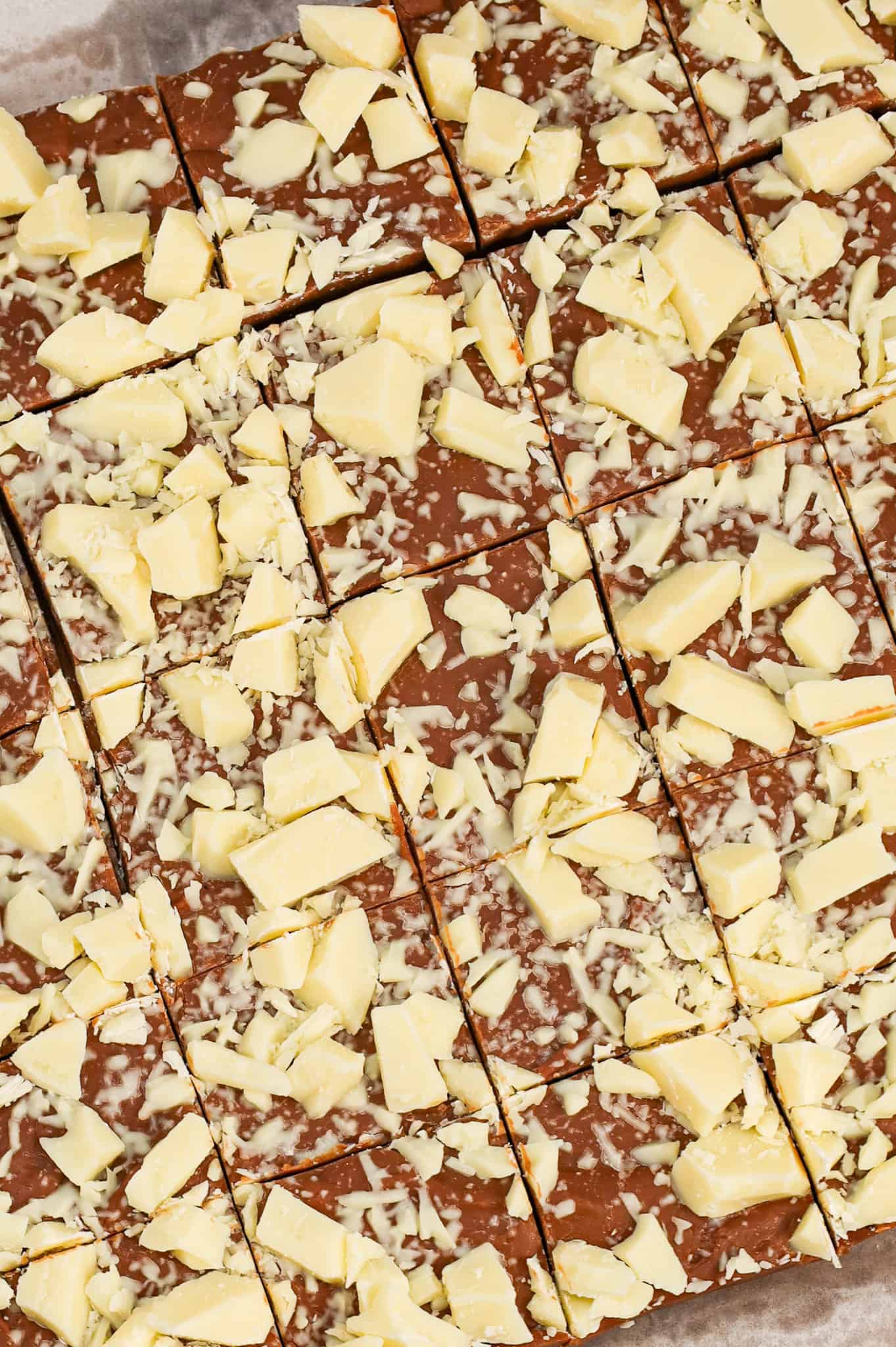 Bailey's Fudge is an easy chocolate fudge recipe made with milk chocolate chips, sweetened condensed milk and Bailey's Irish cream and topped with chopped white chocolate.