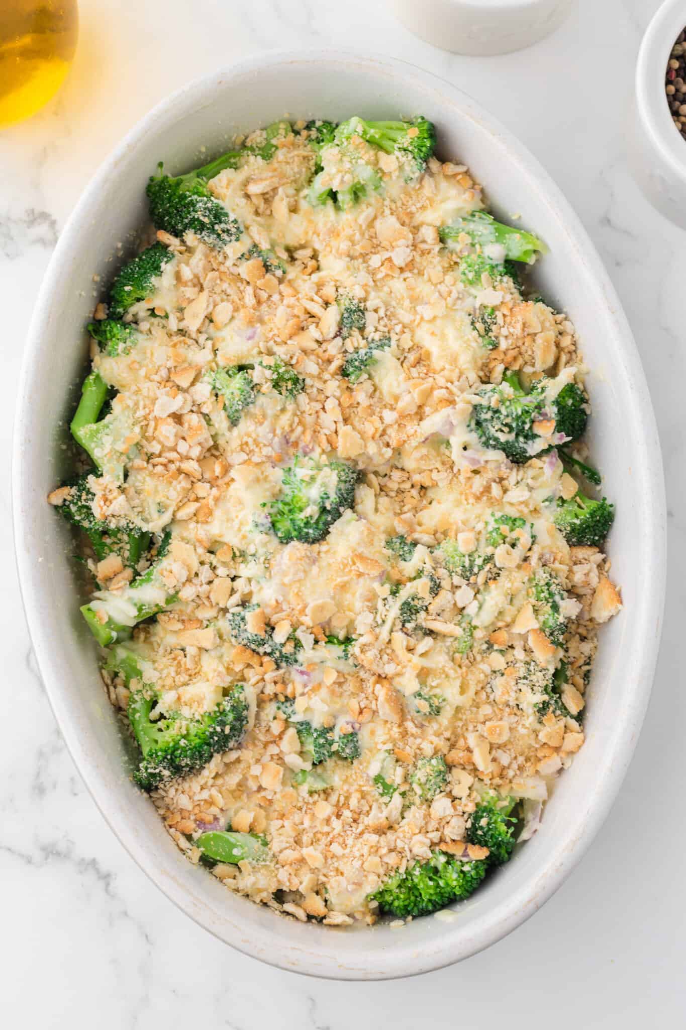crushed Ritz crackers on top of creamy broccoli mixture in a baking dish