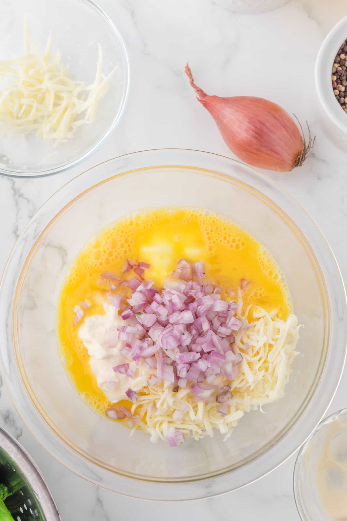 shallots, grated cheese, eggs sour cream and mayo in a mixing bowl