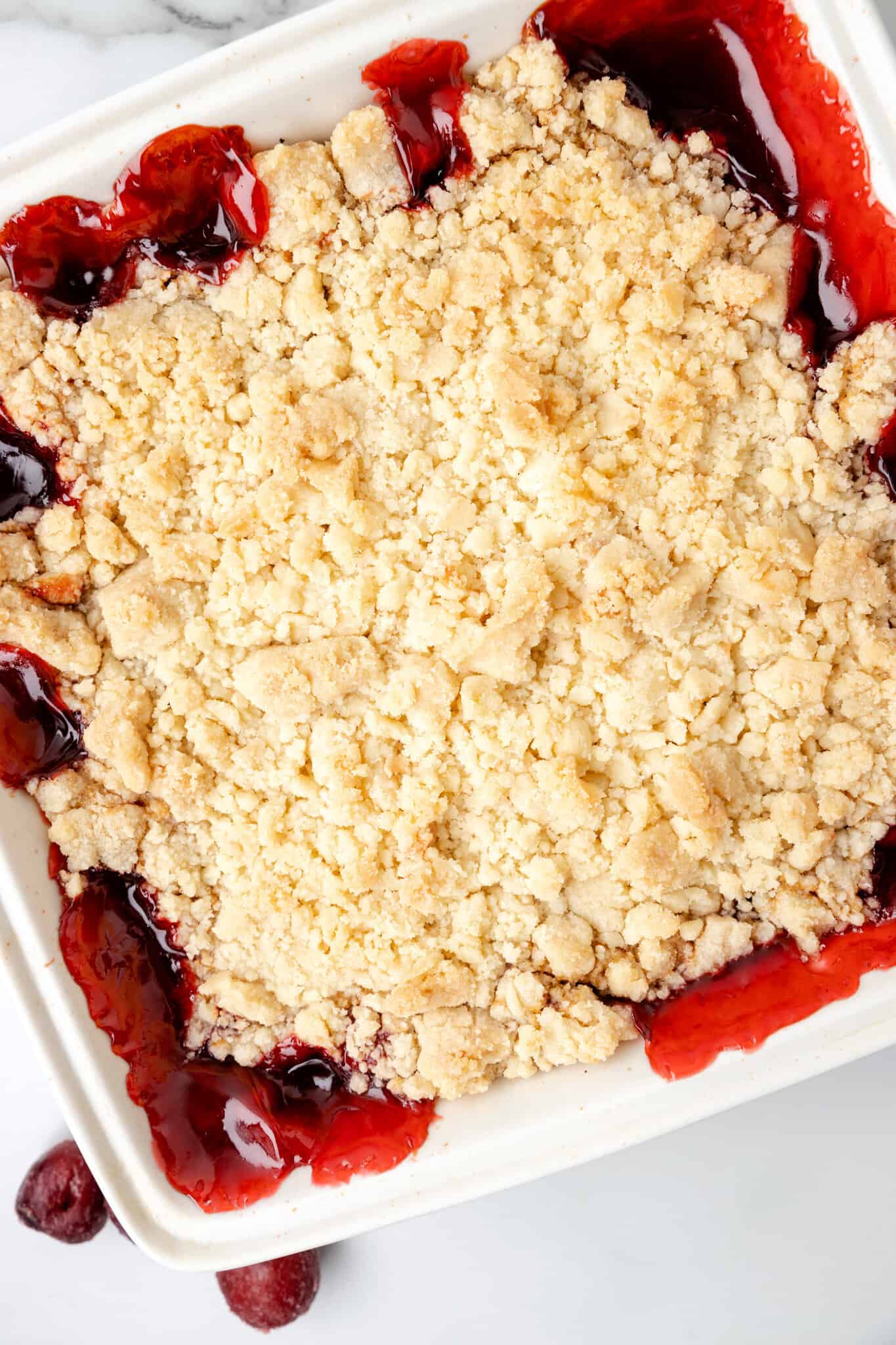 Cherry Cobbler is an easy three ingredient dessert recipe using canned cherry pie filling, sugar cookie mix and butter.