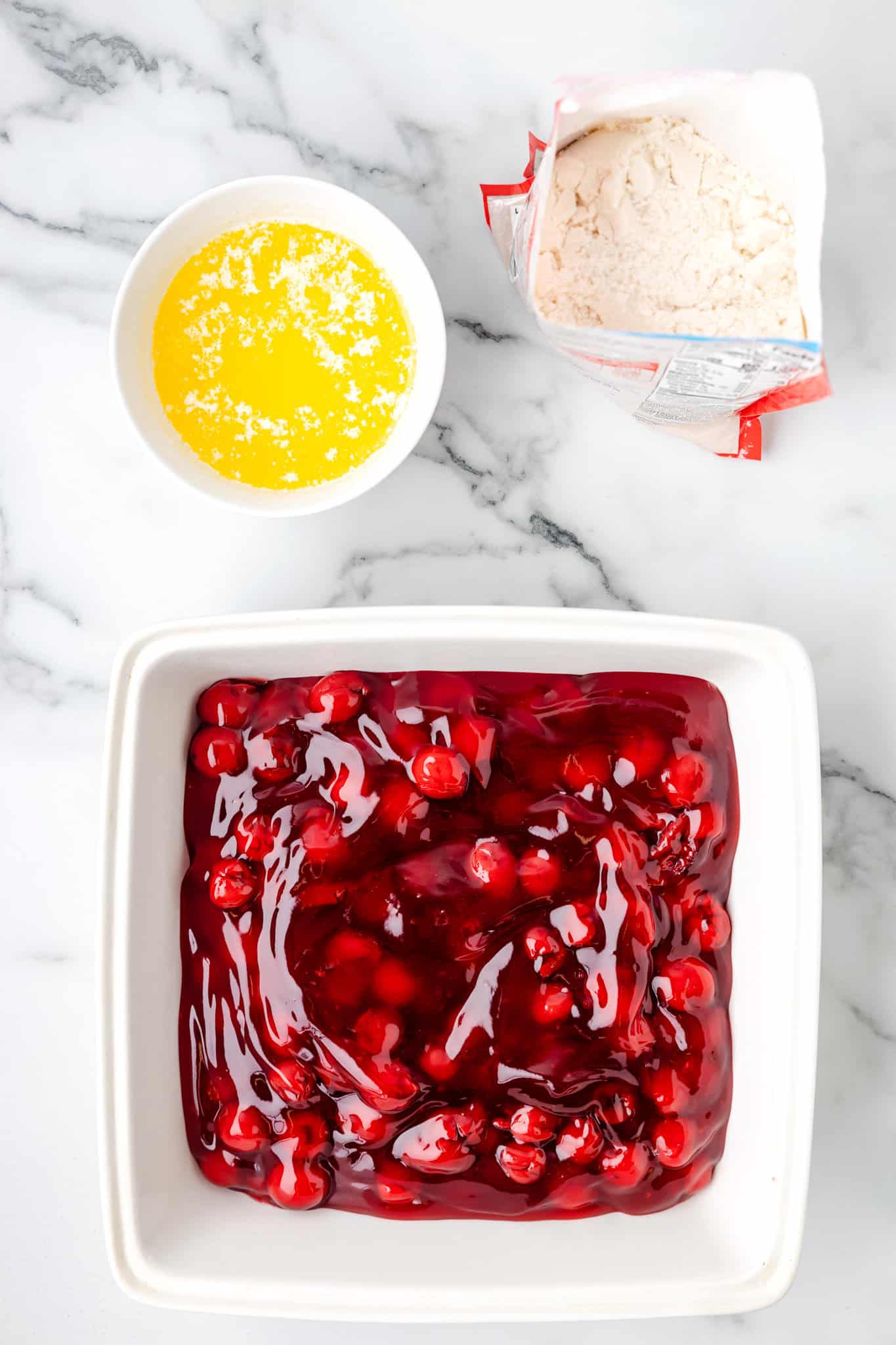 cherry pie filling in a baking dish spread out