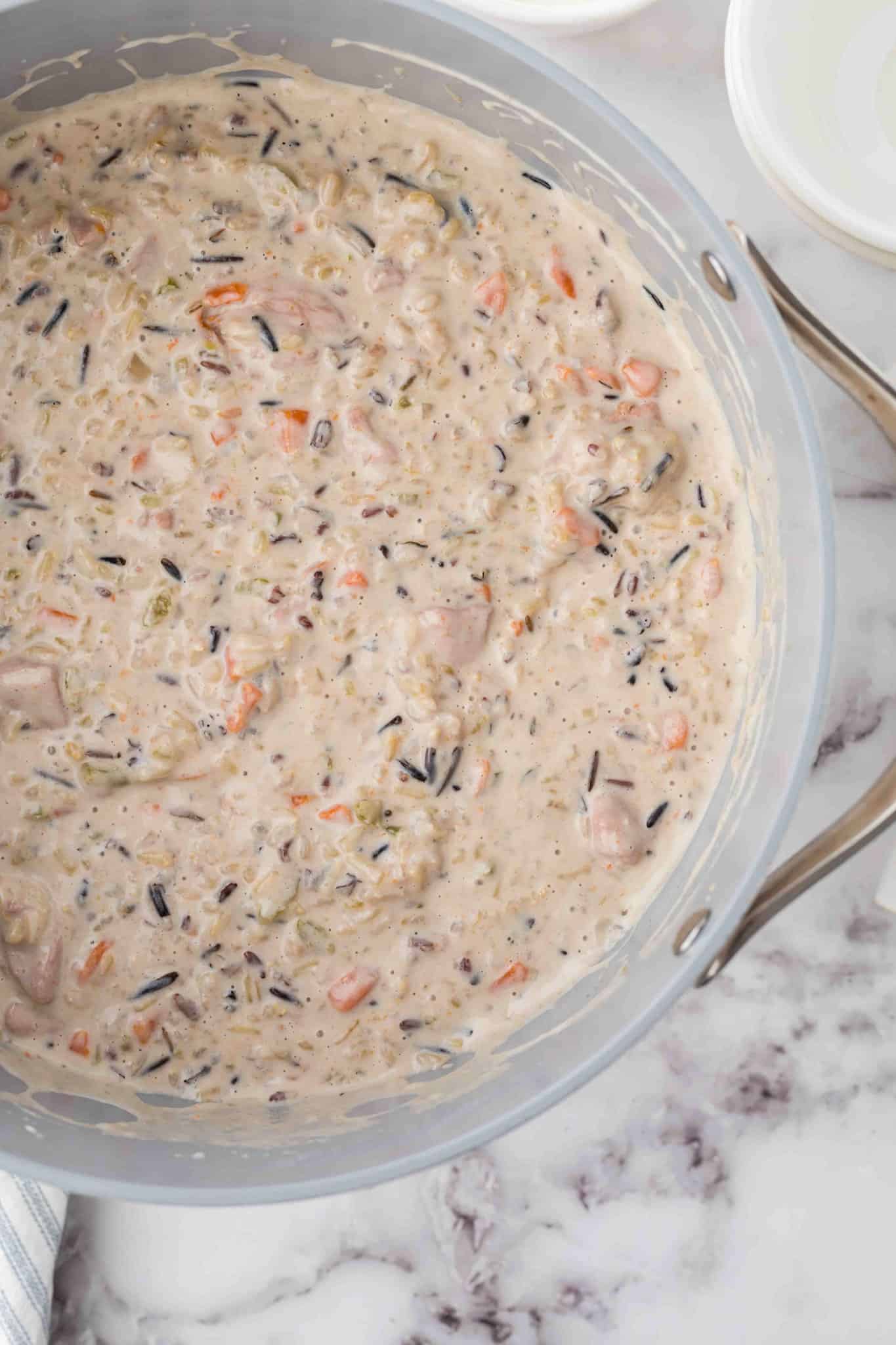Chicken and Wild Rice Soup is a hearty and creamy soup recipe loaded with chunks of chicken, wild rice, carrots, celery, onions and fresh thyme.