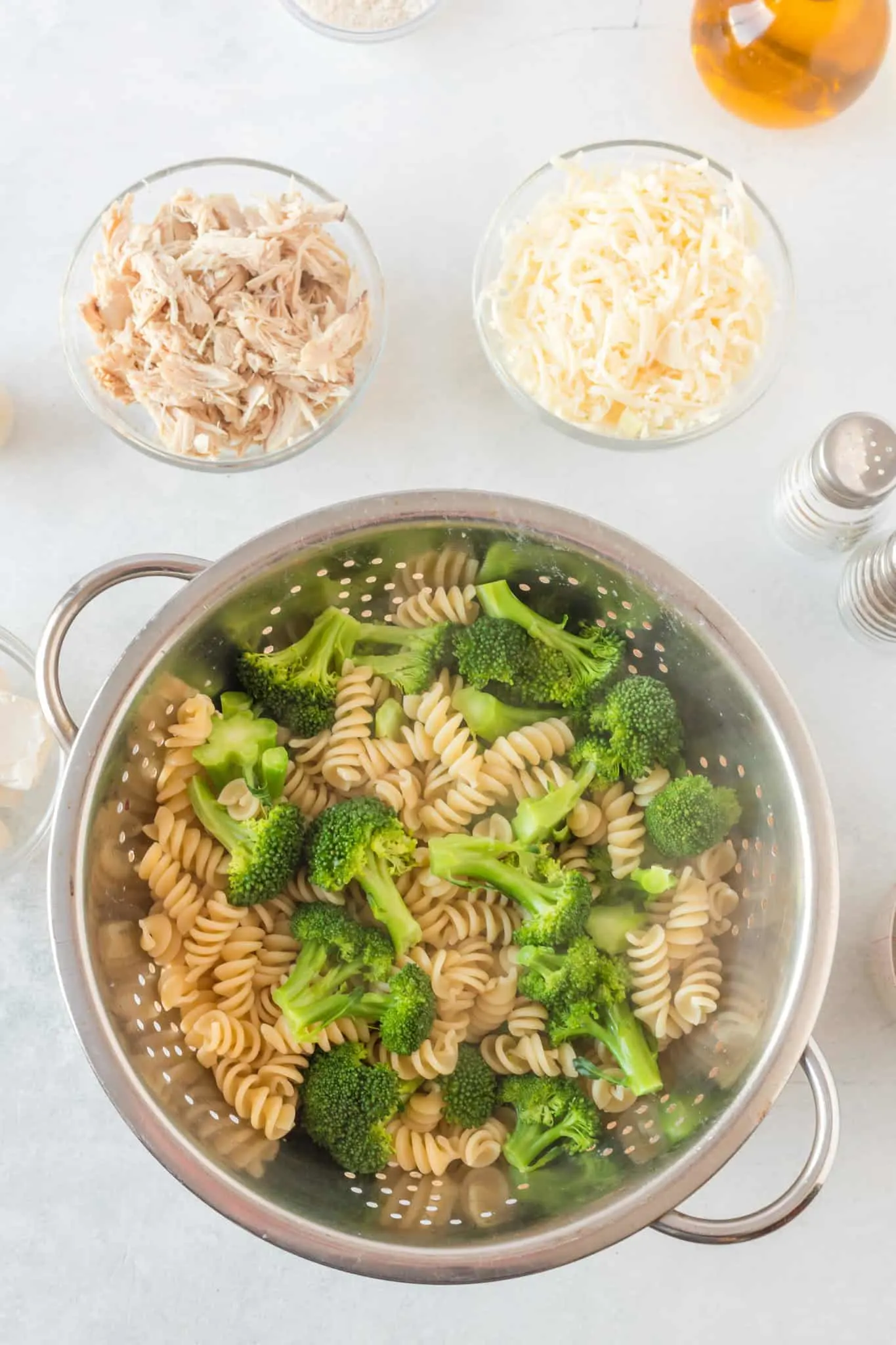 cooked rotini and broccoli in a colander