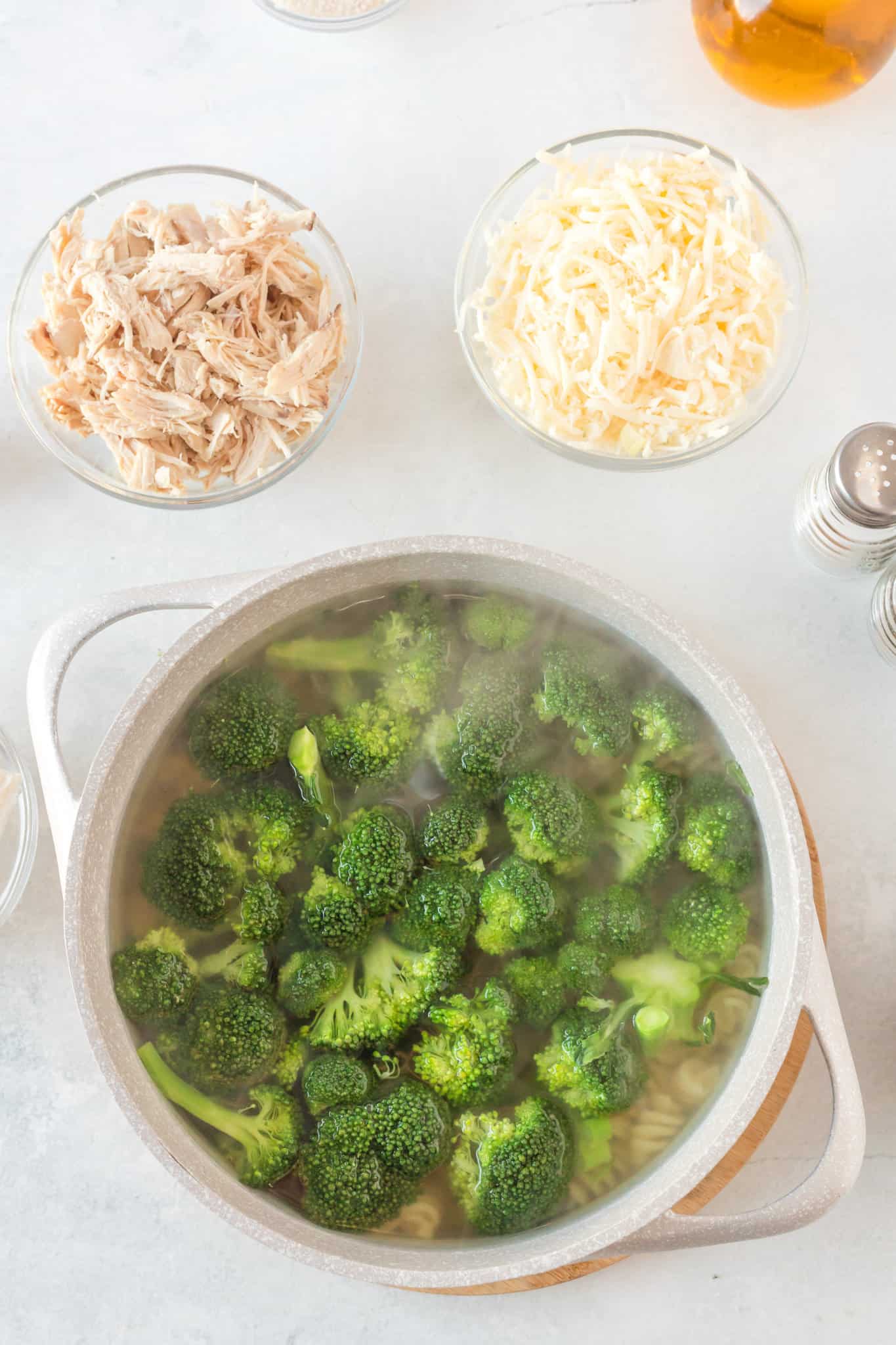 broccoli and rotini cooking in a pot