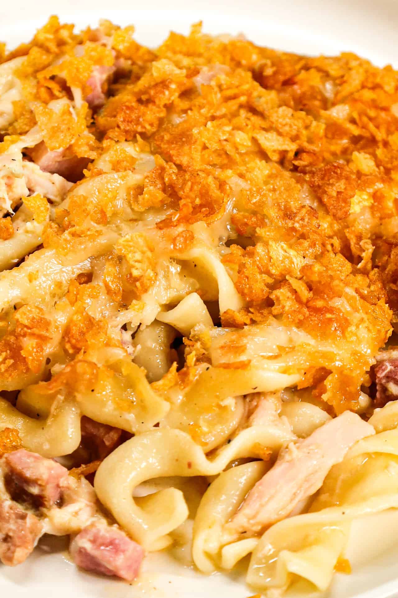 Chicken Cordon Bleu Casserole is an easy casserole recipe loaded with egg noodles, chopped  ham, shredded chicken, cream of chicken soup and topped with Swiss cheese and crumbled cornflakes.