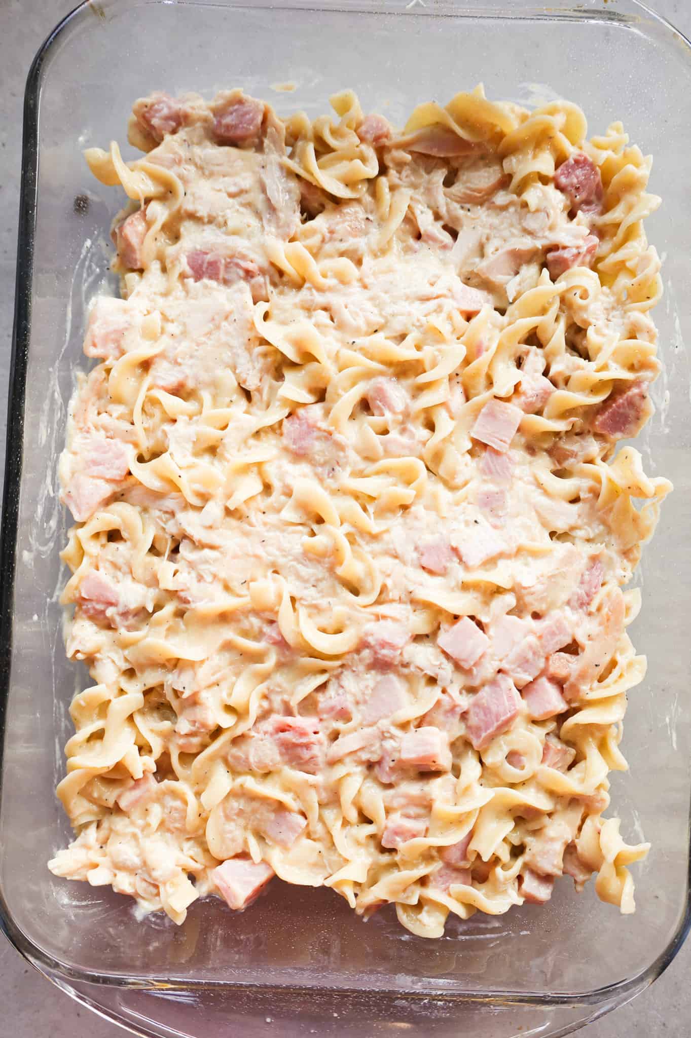 chicken, ham and egg noodle mixture in a baking dish