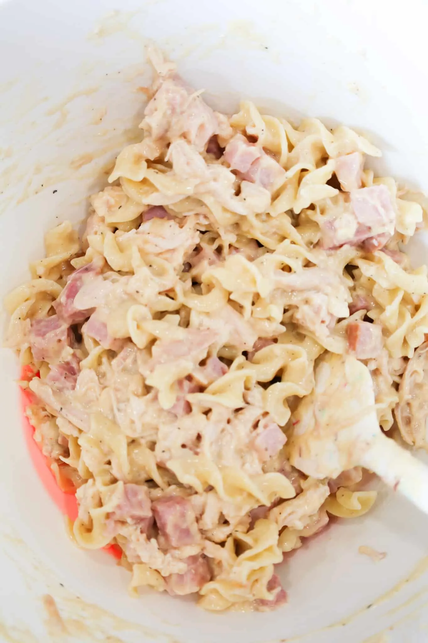 chicken, ham and egg noodle mixture in a mixing bowl