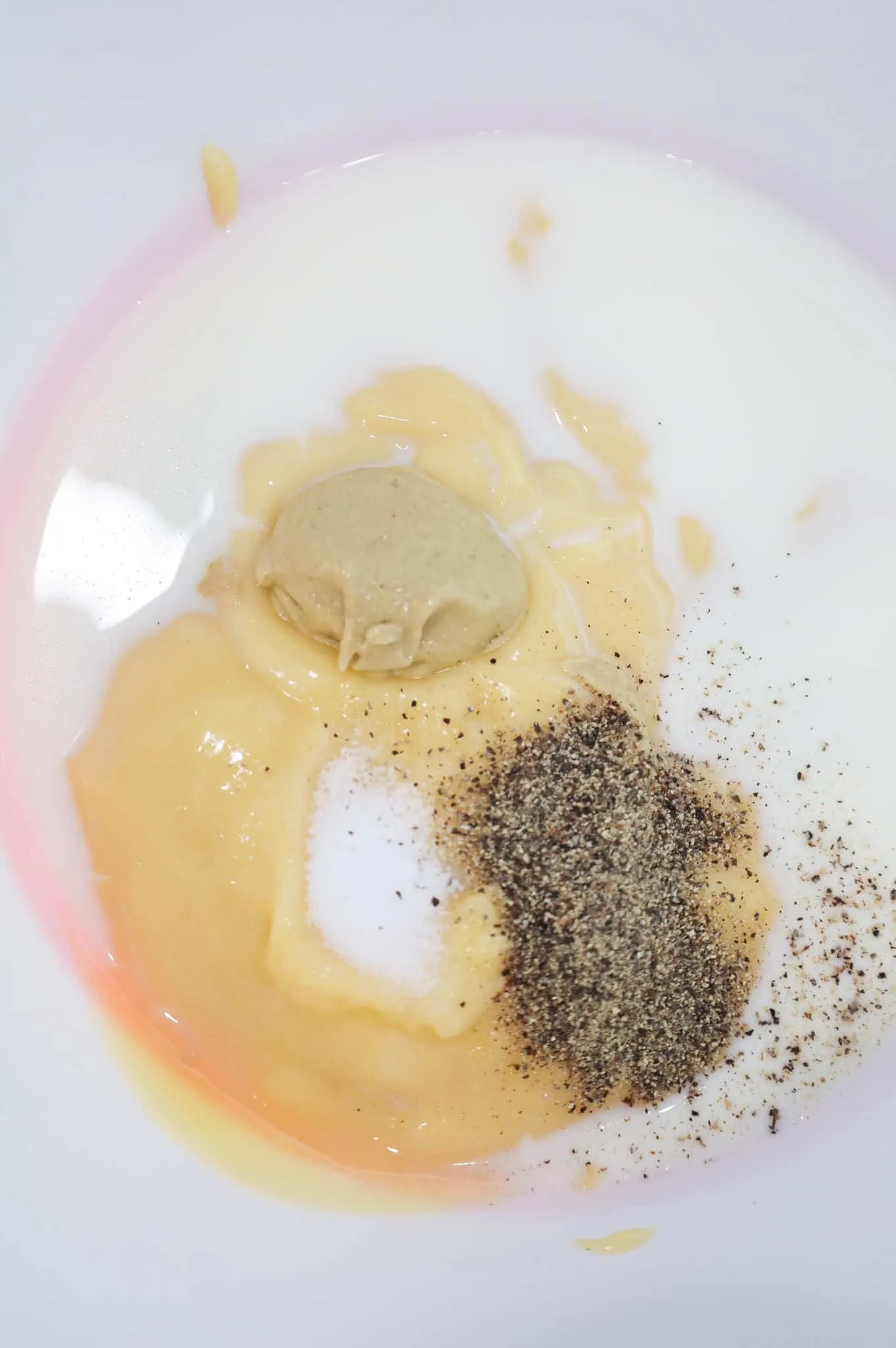 salt, pepper, Dijon mustard, milk and cream of chicken soup in a mixing bowl