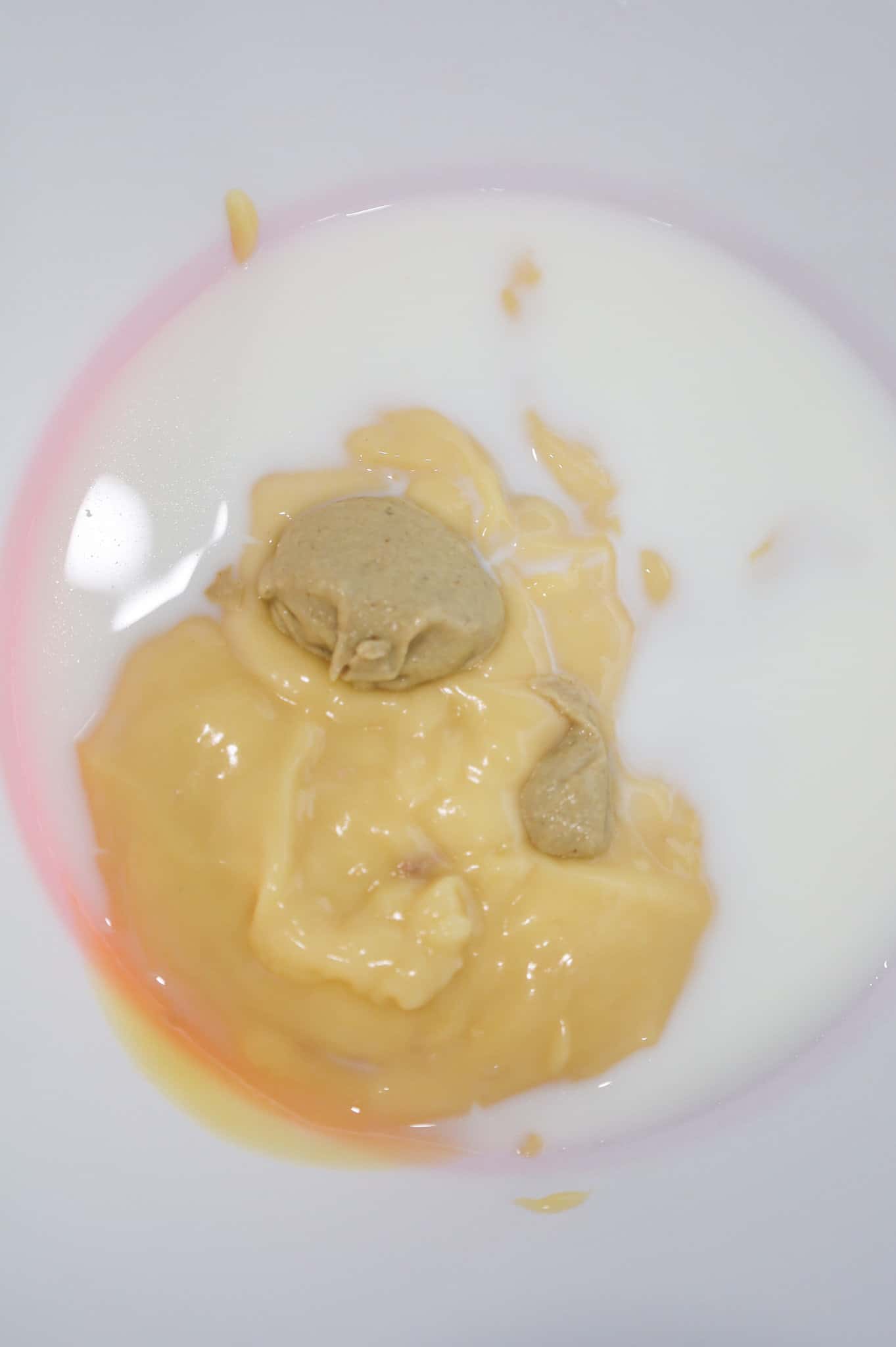 cream of chicken soup, milk and Dijon mustard in a mixing bowl