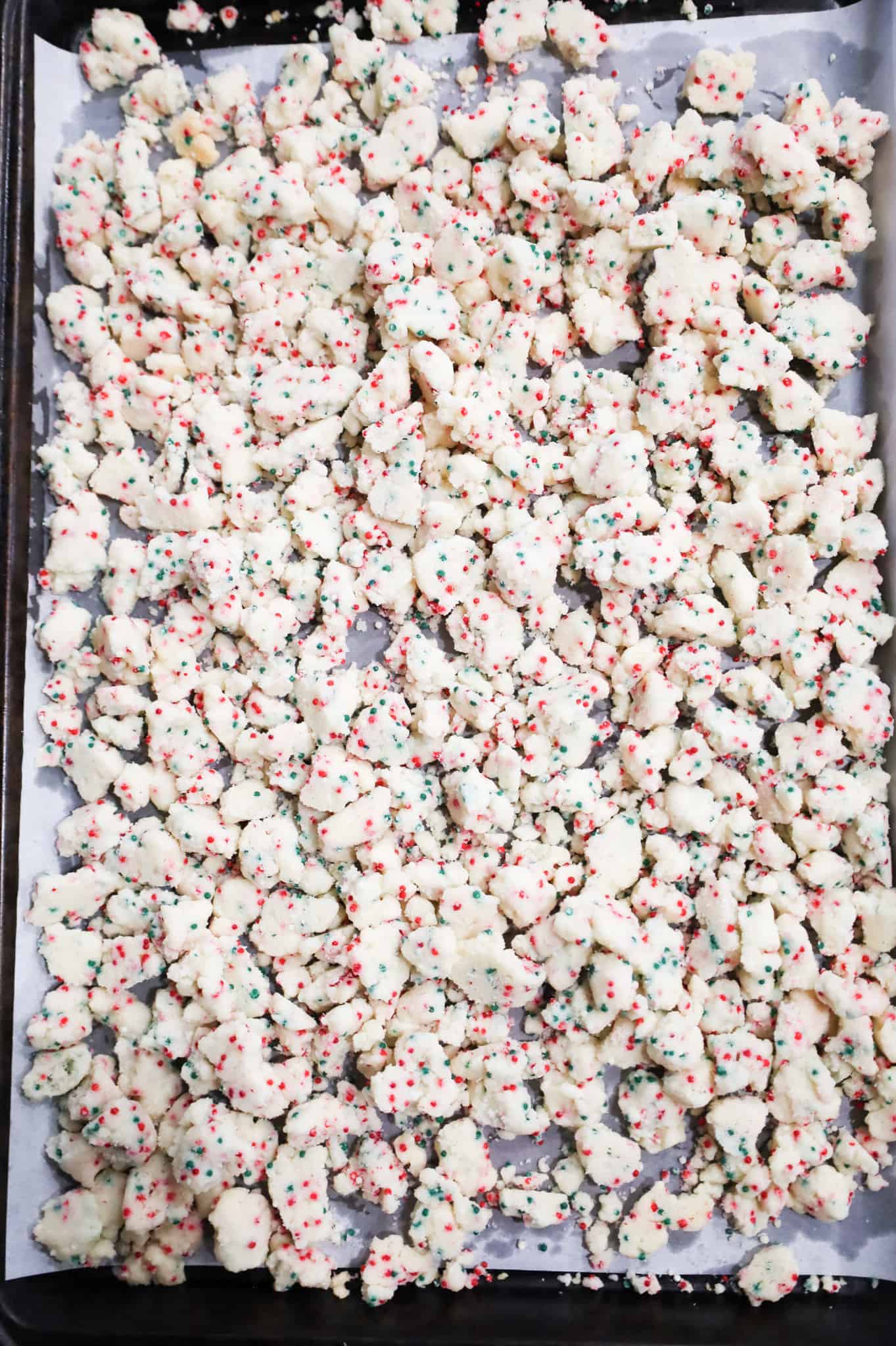 sugar cookie crumble on a parchment lined baking sheet