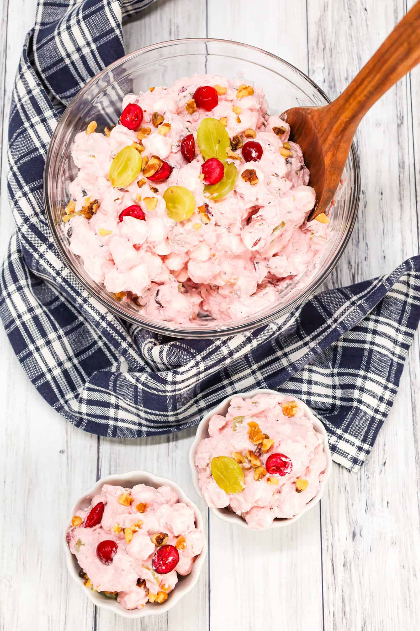 Cranberry Fluff is a delicious Thanksgiving side dish recipe made with whole berry cranberry sauce, chopped green grapes, Cool whip, mini marshmallows and chopped walnuts.