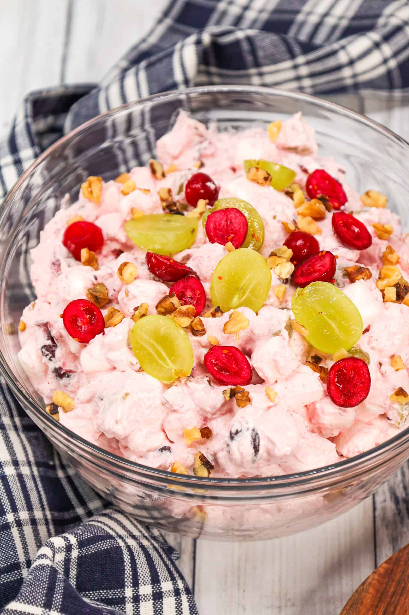 Cranberry Fluff is a delicious Thanksgiving side dish recipe made with whole berry cranberry sauce, chopped green grapes, Cool whip, mini marshmallows and chopped walnuts.