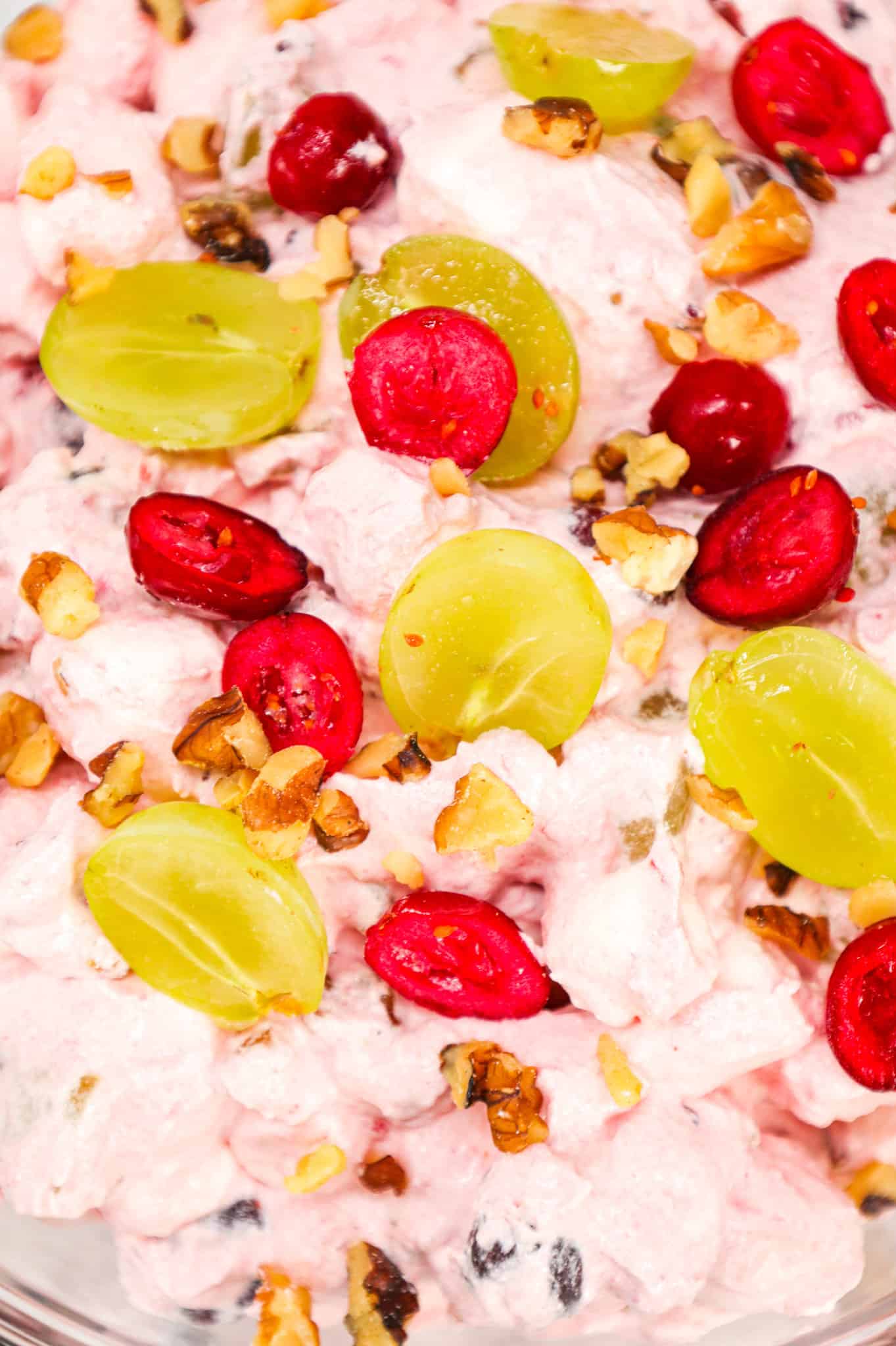 Cranberry Fluff is a delicious Thanksgiving side dish recipe made with whole berry cranberry sauce, chopped green grapes, Cool whip, mini marshmallows and chopped walnuts.