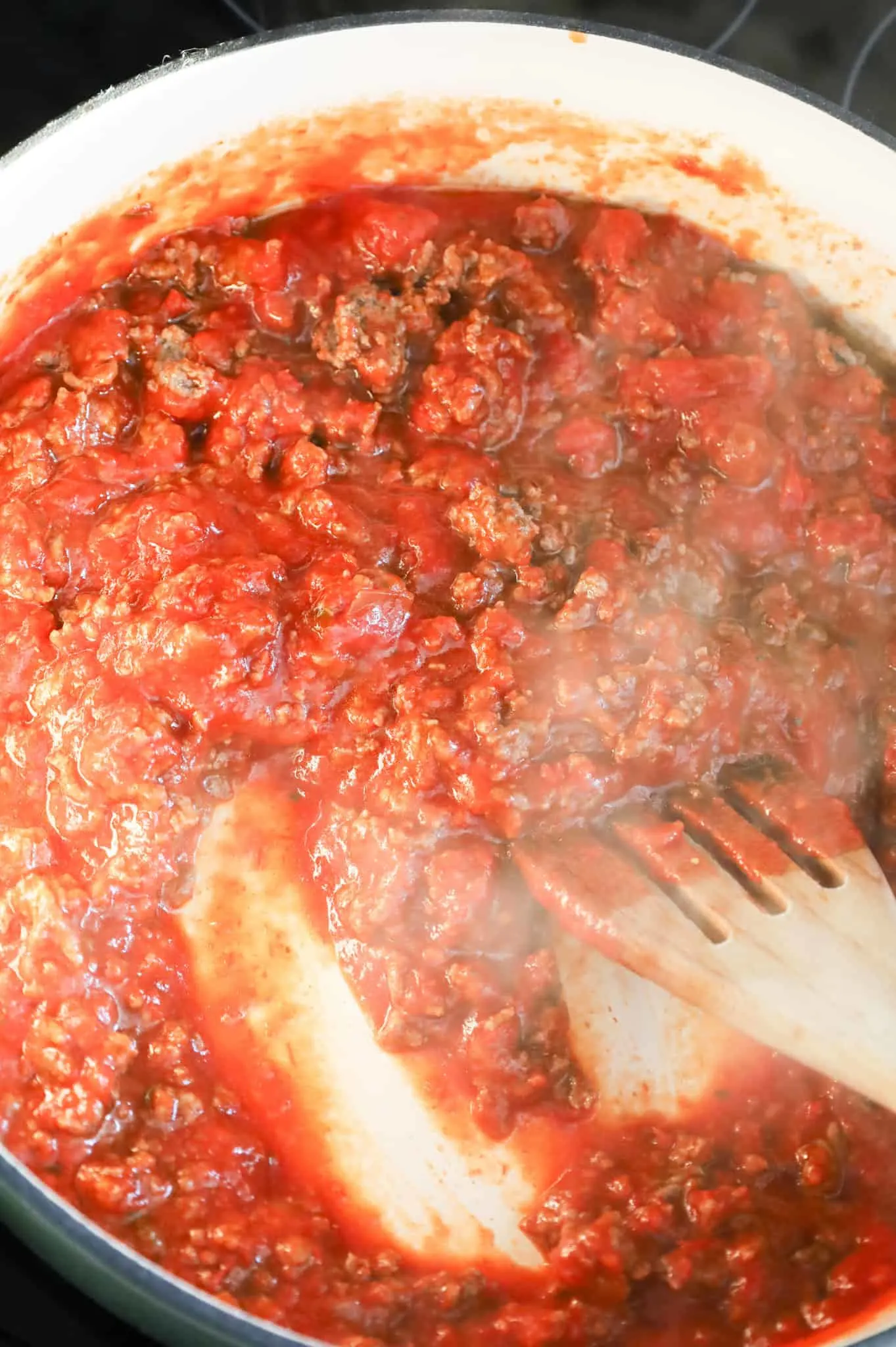 marinara, spices and ground beef mixture in a skillet