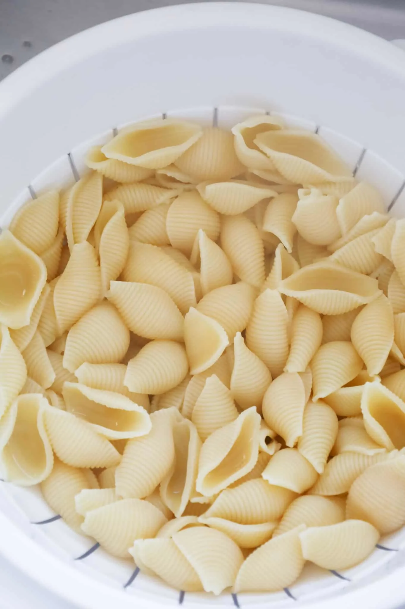 cooked pasta shells in a colander