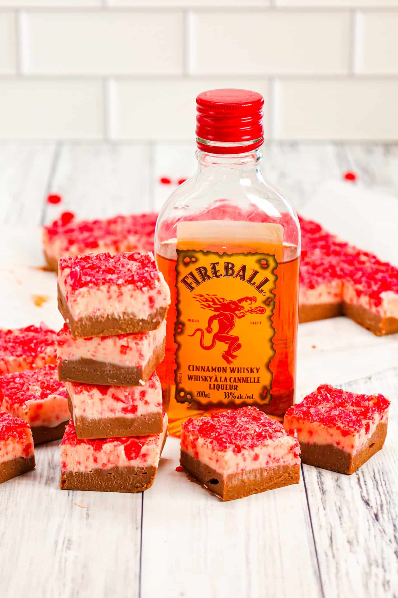 Fireball Fudge is a simple microwave fudge recipe with a milk chocolate layer and a white chocolate layer both containing Fireball cinnamon whisky and topped with crushed cinnamon hearts.