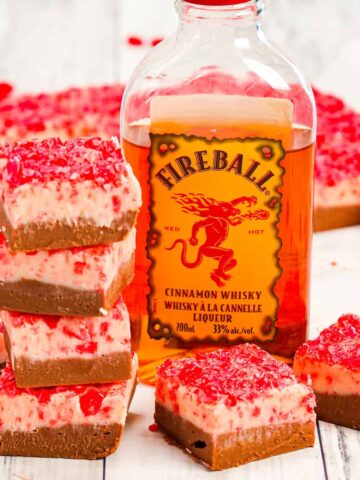Fireball Fudge is a simple microwave fudge recipe with a milk chocolate layer and a white chocolate layer both containing Fireball cinnamon whisky and topped with crushed cinnamon hearts.