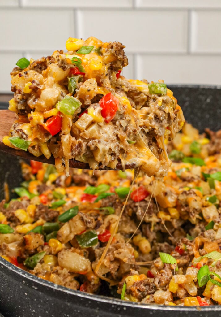 Ground Beef and Potatoes is an easy weeknight dinner recipe loaded with diced hash brown potatoes, ground beef, corn, diced bell peppers, cream of mushroom soup and shredded cheddar cheese.