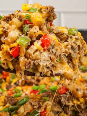 Ground Beef and Potatoes is an easy weeknight dinner recipe loaded with diced hash brown potatoes, ground beef, corn, diced bell peppers, cream of mushroom soup and shredded cheddar cheese.