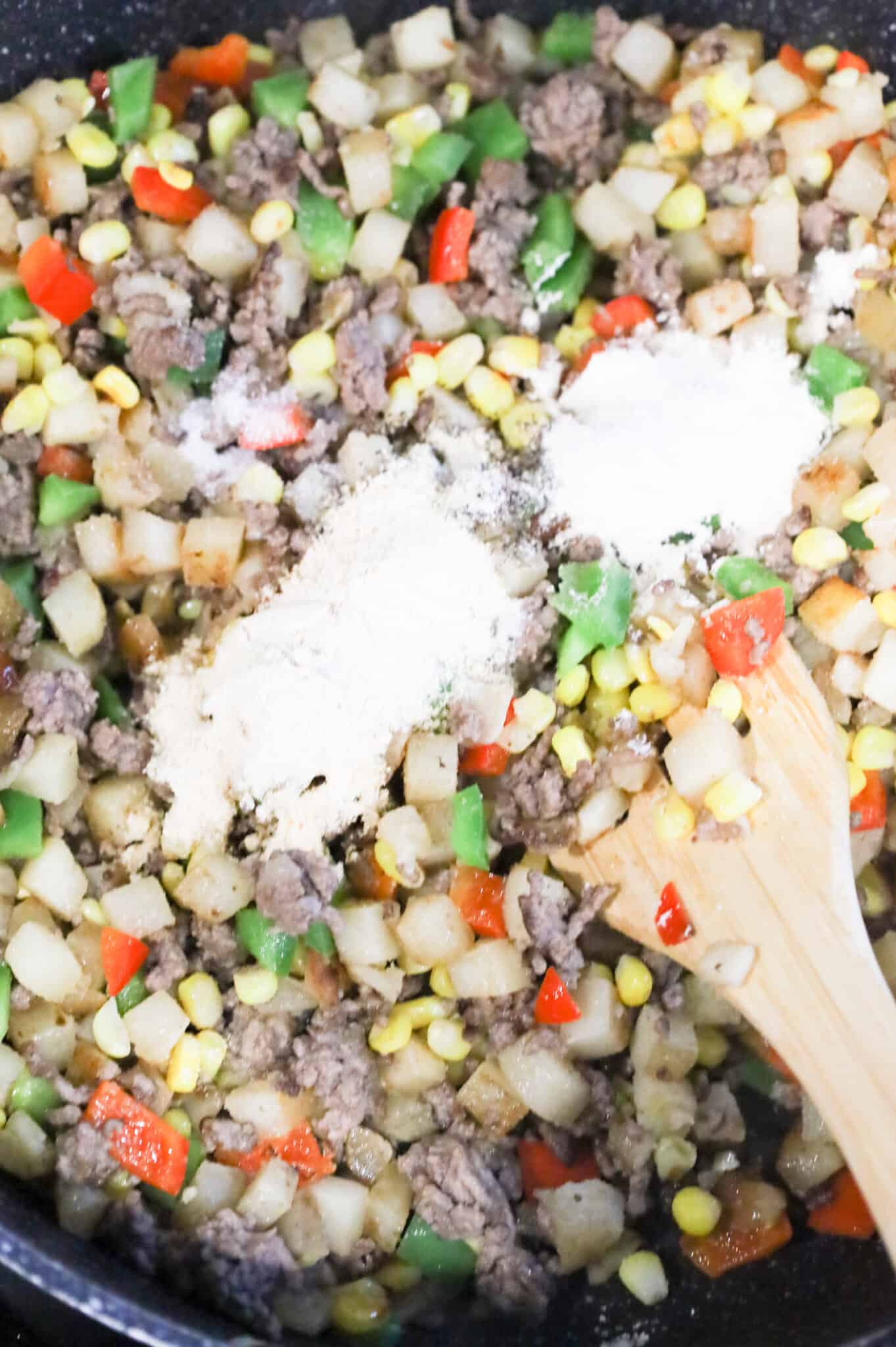 spices added to skillet with ground beef and potato mixture