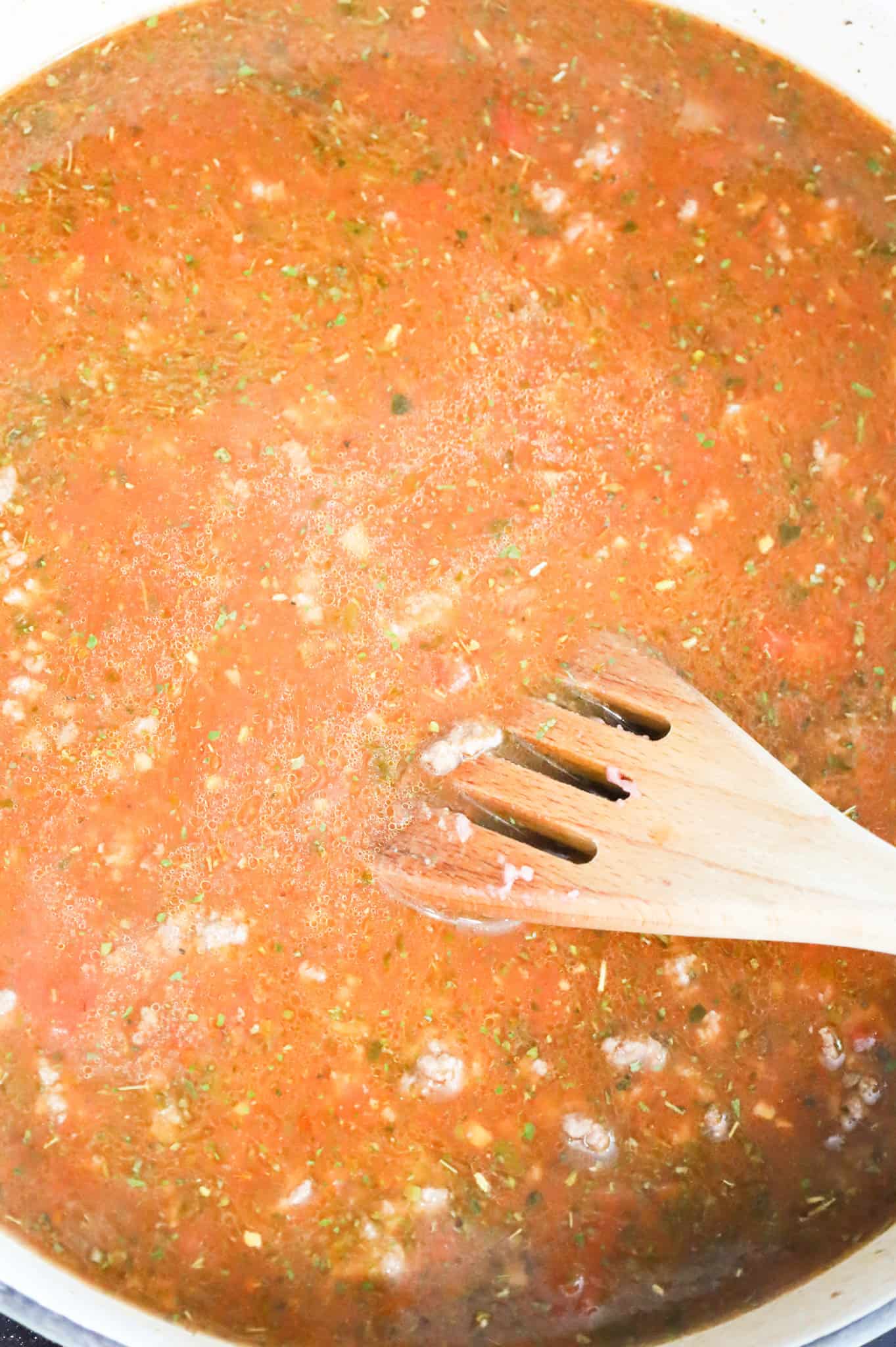 stirring together beef broth, marinara and Italian seasoning in a skillet