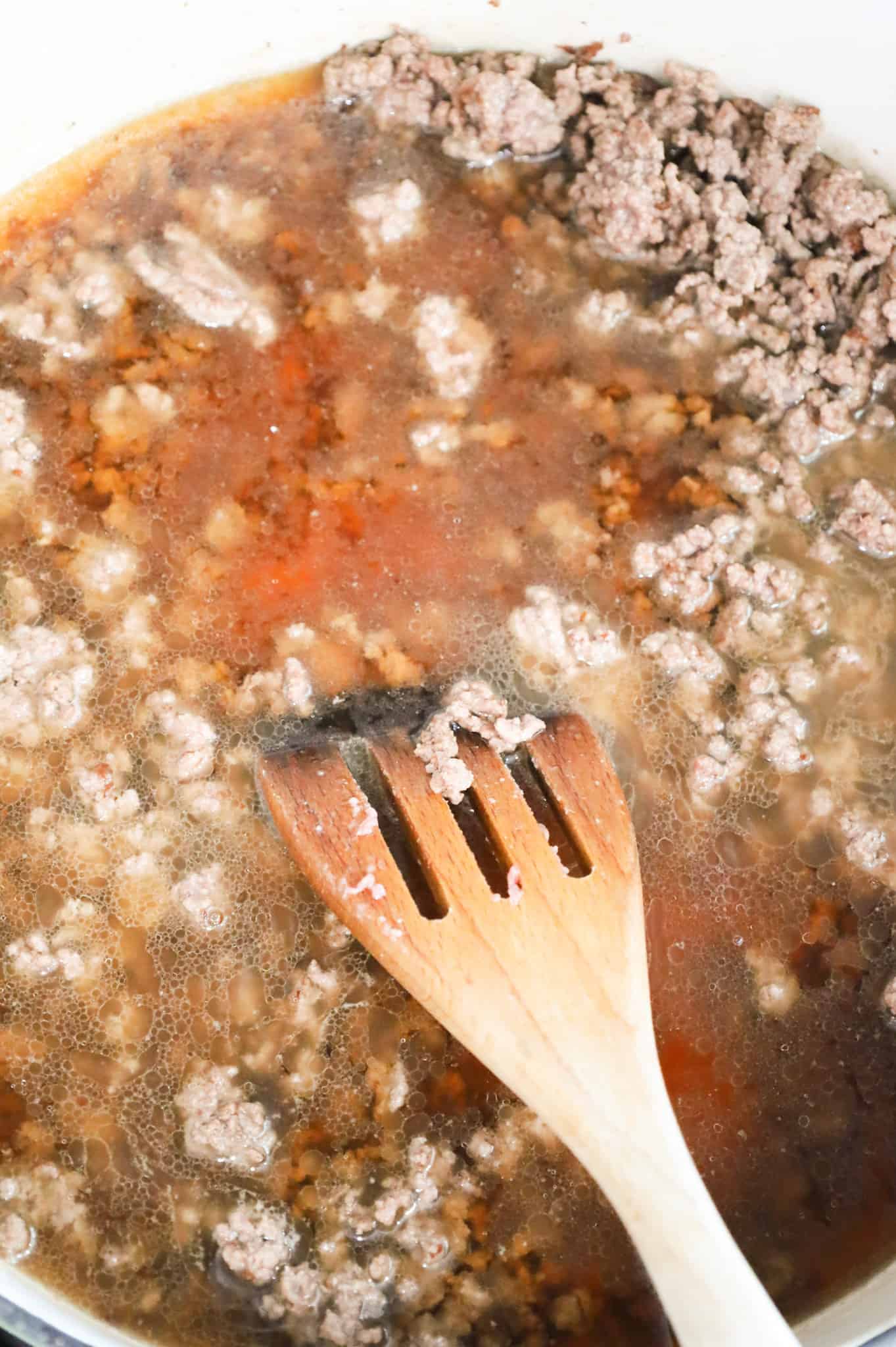 beef broth added to skillet with cooked ground beef