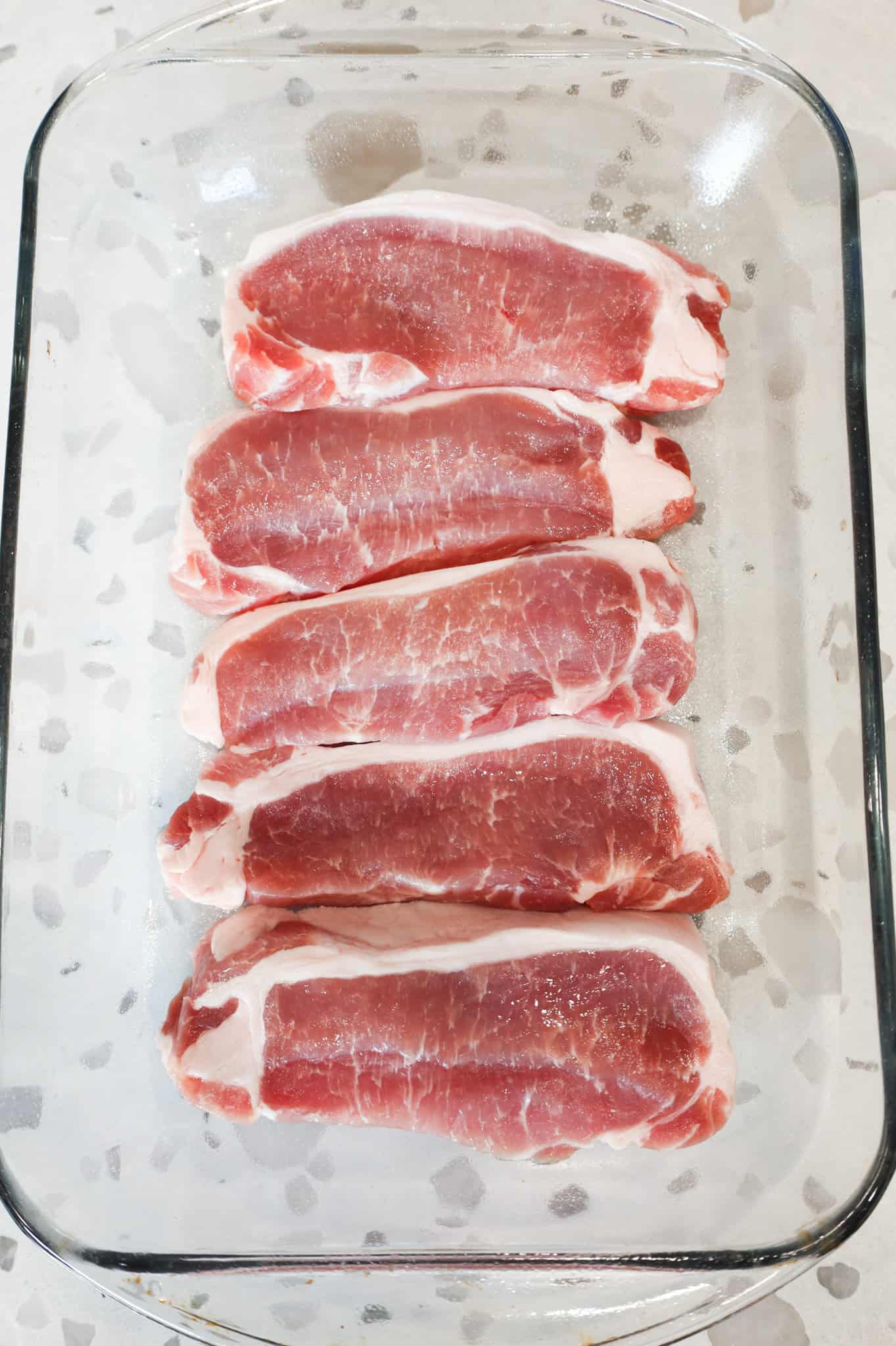 boneless pork chops in a baking dish