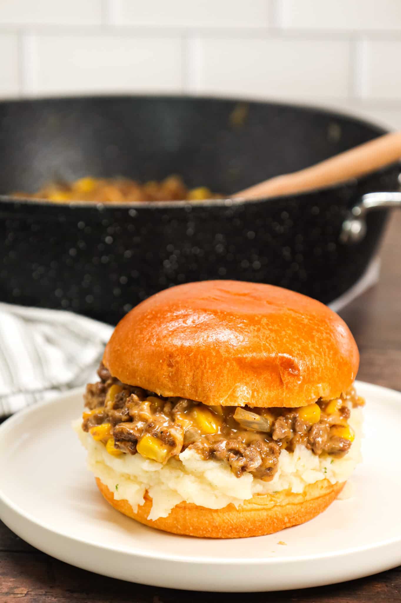 Shepherd's Pie Sloppy Joes are a hearty ground beef dinner recipe made with instant mashed potatoes, corn, diced onions, brown gravy mix and shredded cheese all served on toasted Brioche buns.