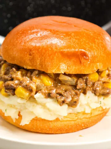 Shepherd's Pie Sloppy Joes are a hearty ground beef dinner recipe made with instant mashed potatoes, corn, diced onions, brown gravy mix and shredded cheese all served on toasted Brioche buns.