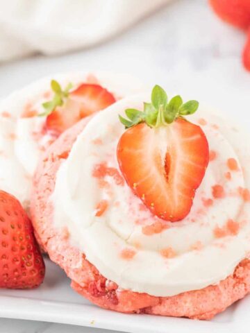 Strawberry Cheesecake Cookies are simple and delicious cookies made with boxed strawberry cake mix and fresh chopped strawberries, topped with a homemade cream cheese frosting.