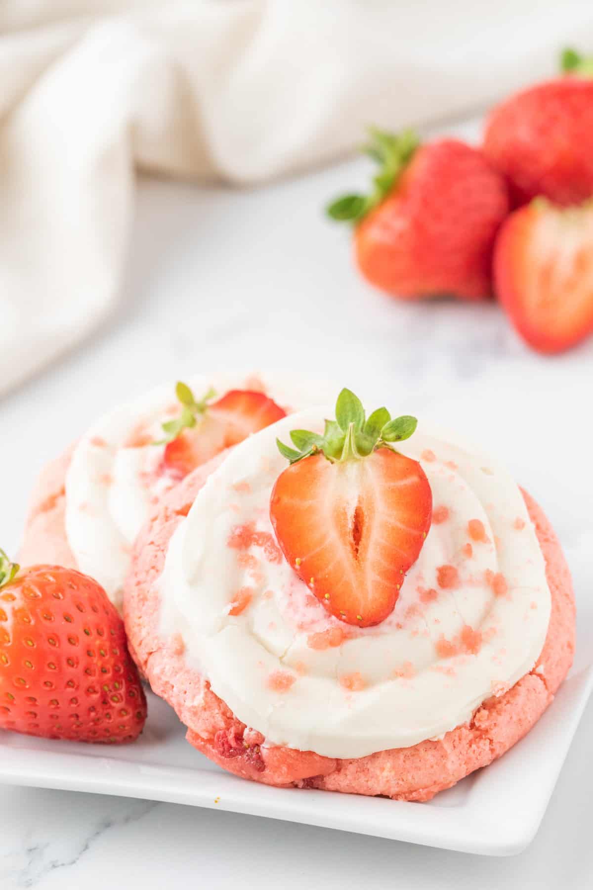 Strawberry Cheesecake Cookies are simple and delicious cookies made with boxed strawberry cake mix and fresh chopped strawberries, topped with a homemade cream cheese frosting.