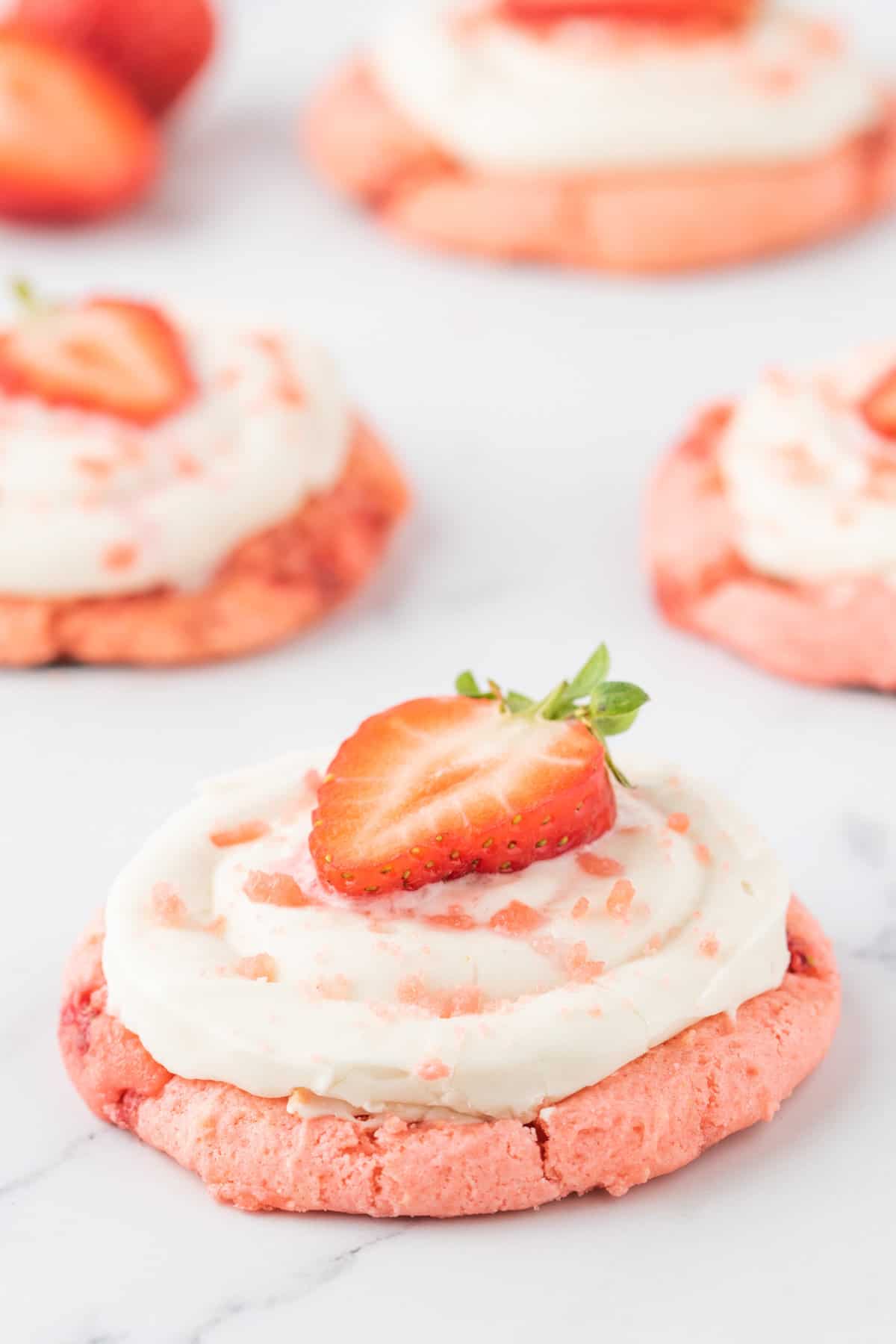 Strawberry Cheesecake Cookies are simple and delicious cookies made with boxed strawberry cake mix and fresh chopped strawberries, topped with a homemade cream cheese frosting.