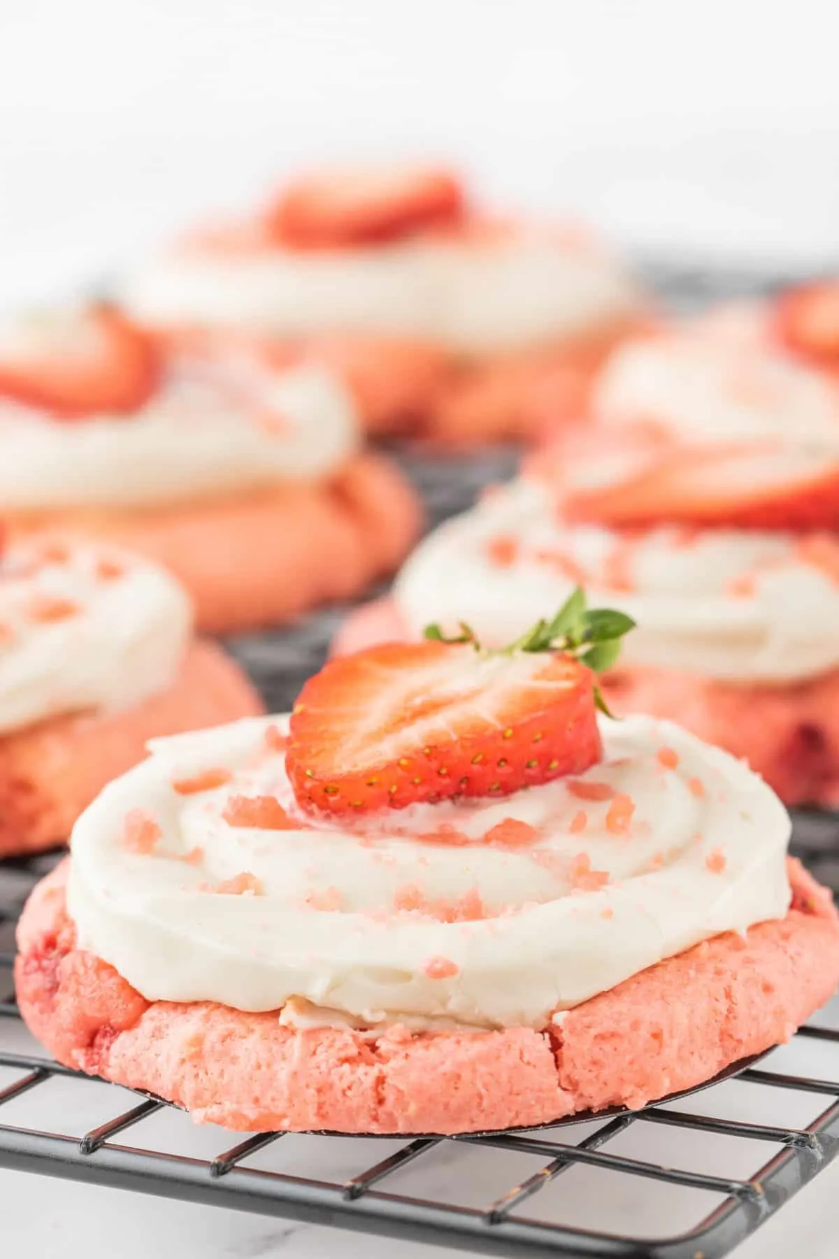 Strawberry Cheesecake Cookies are simple and delicious cookies made with boxed strawberry cake mix and fresh chopped strawberries, topped with a homemade cream cheese frosting.