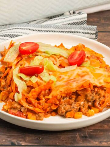 Taco Casserole with Doritos is an easy ground beef casserole recipe loaded with Rotel diced tomatoes and green chilies, salsa, cheddar cheese soup, corn, crumbled Doritos nacho chips and shredded cheese.