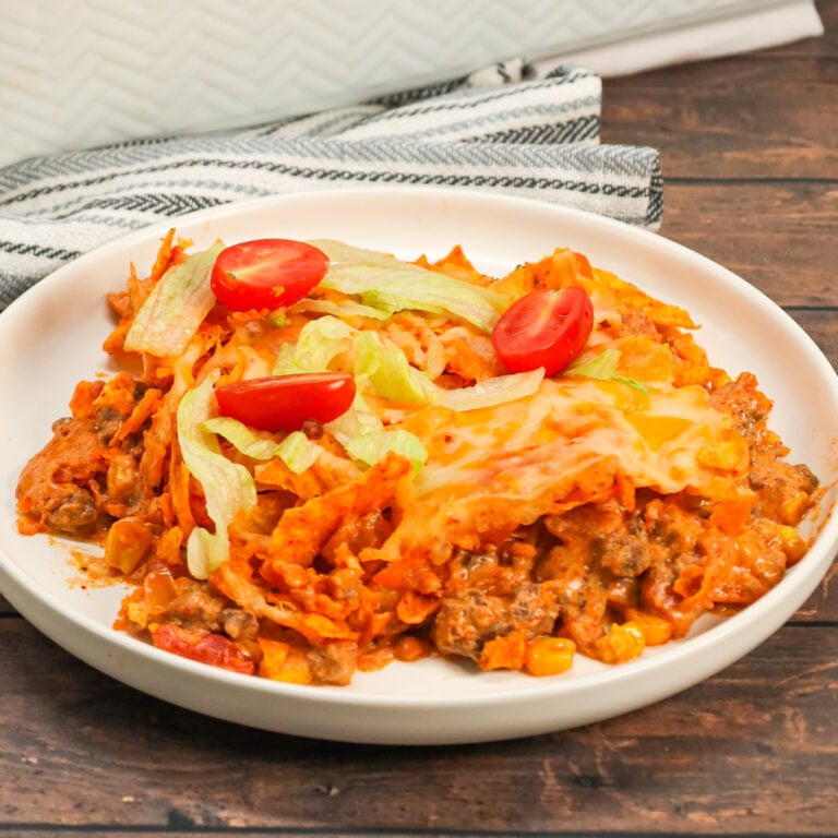 Taco Casserole with Doritos is an easy ground beef casserole recipe loaded with Rotel diced tomatoes and green chilies, salsa, cheddar cheese soup, corn, crumbled Doritos nacho chips and shredded cheese.
