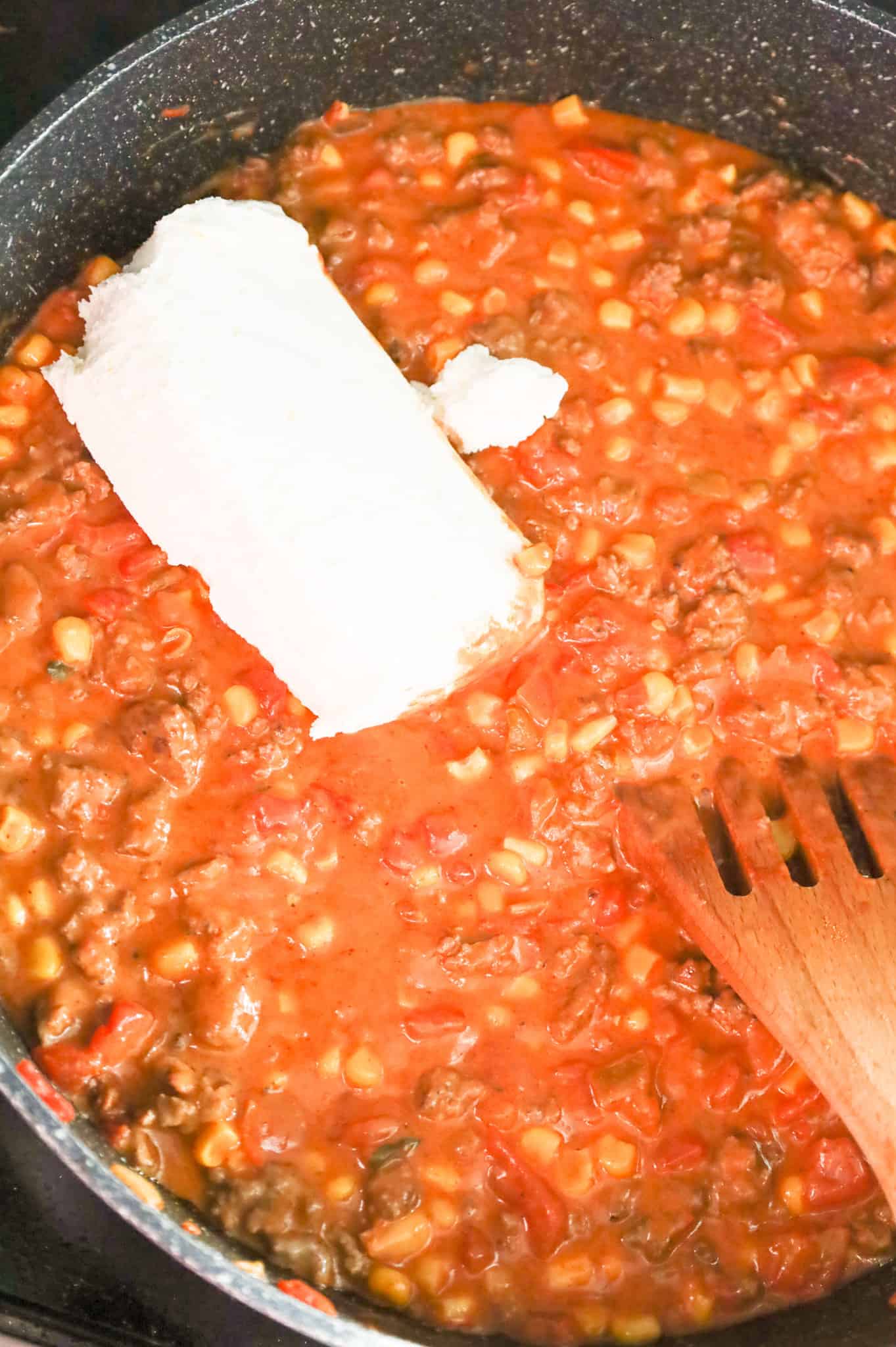 cream cheese added to skillet with ground beef, salsa and rotel mixture