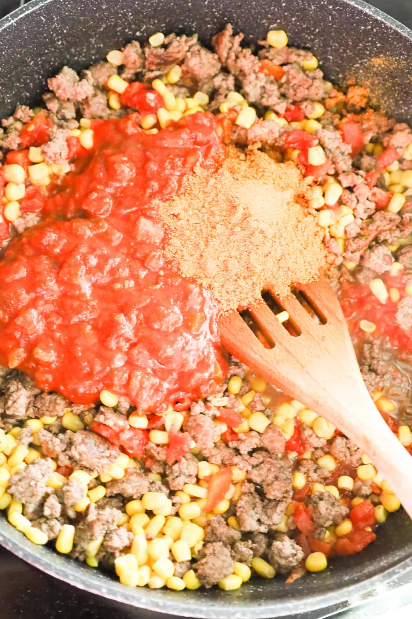 salsa and taco seasoning added to skillet with ground beef and corn mixture