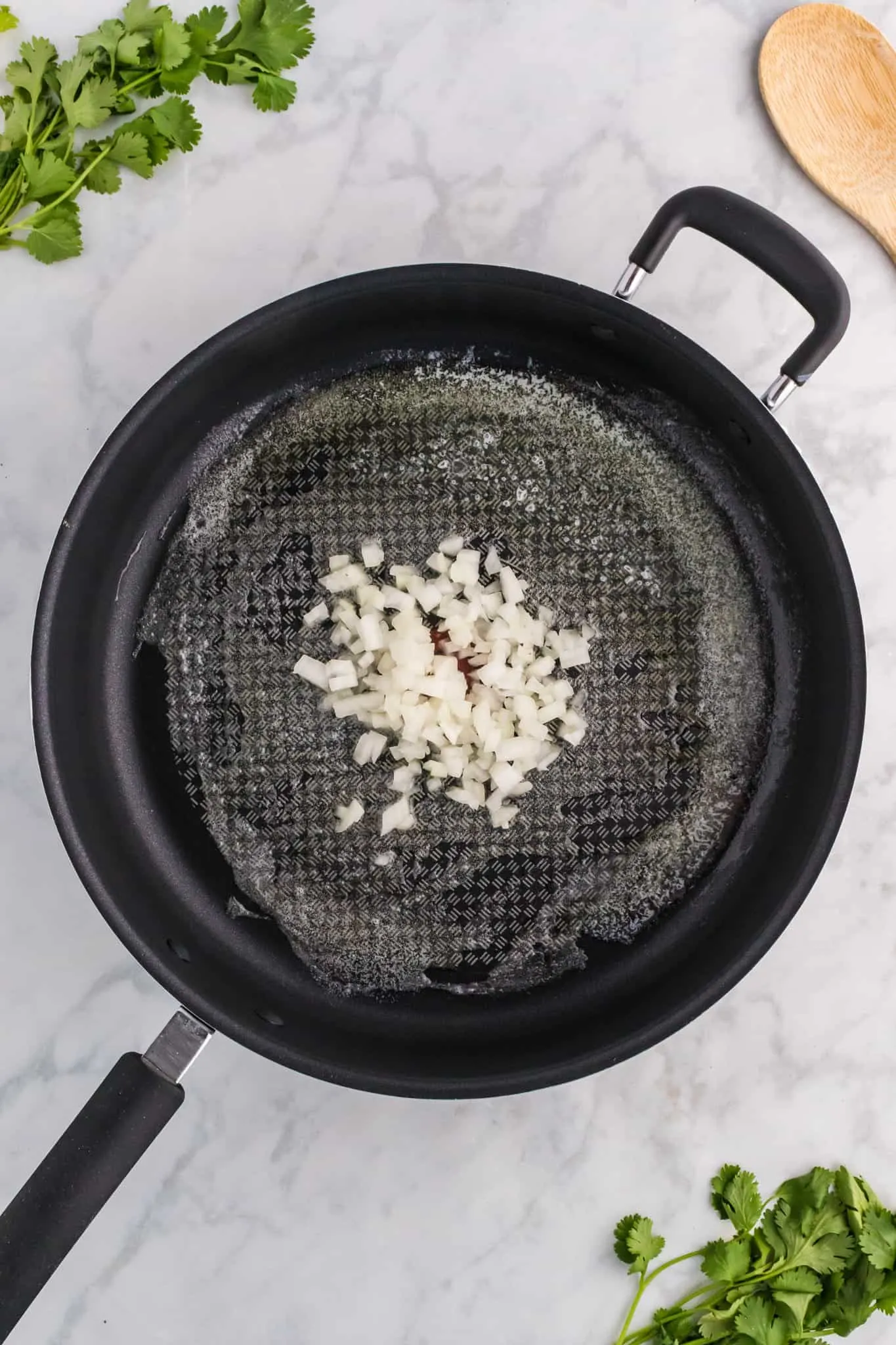 diced onions in a pan with melted butter