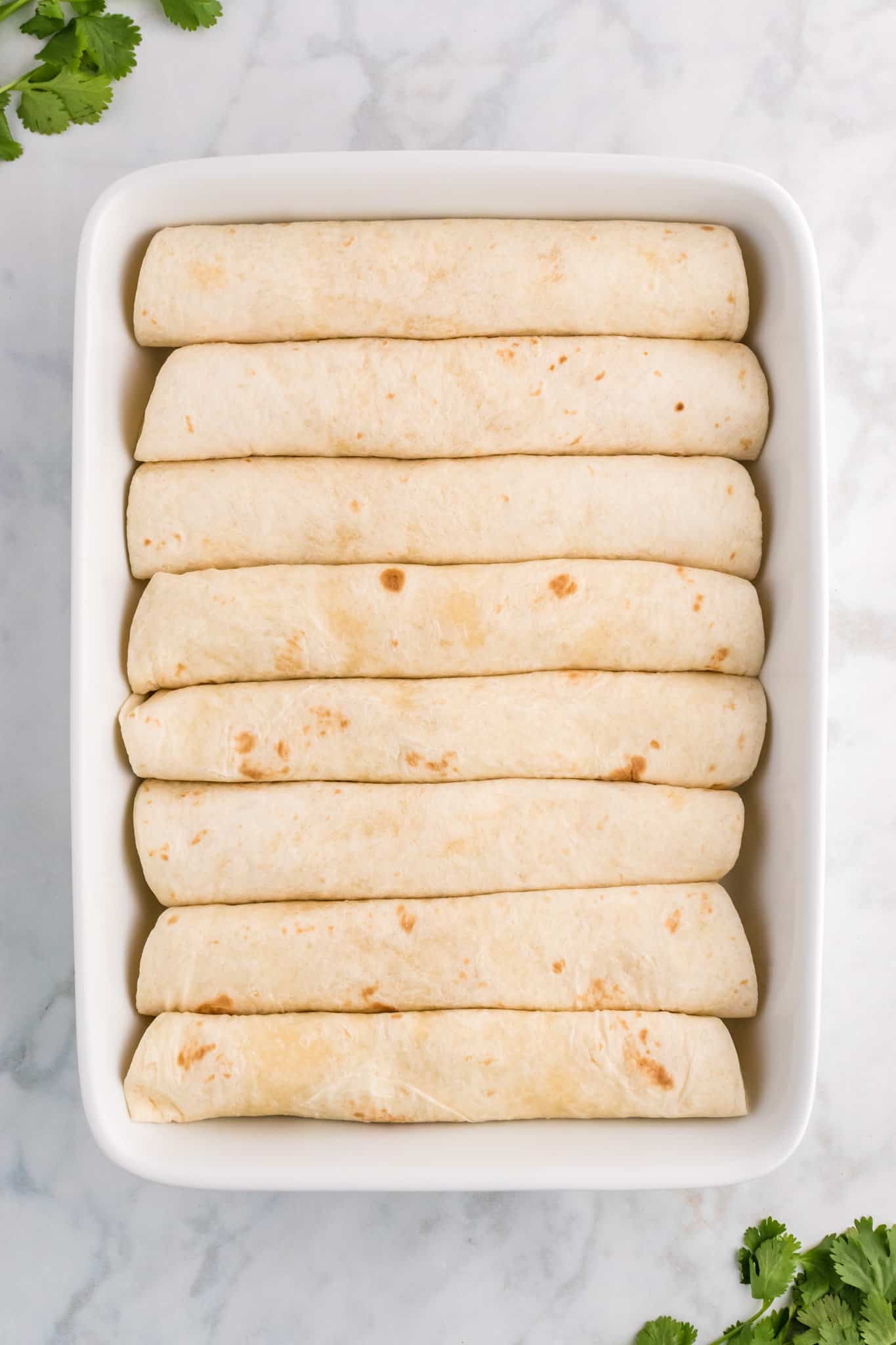 rolled tortillas in a baking dish