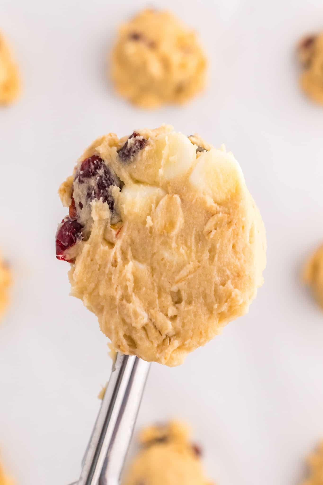 cranberry oatmeal cookie dough in a cookie scoop