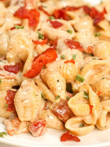 Bacon Pasta is a creamy shell pasta recipe loaded with crispy crumbled bacon pieces and flavoured with garlic and parmesan cheese.