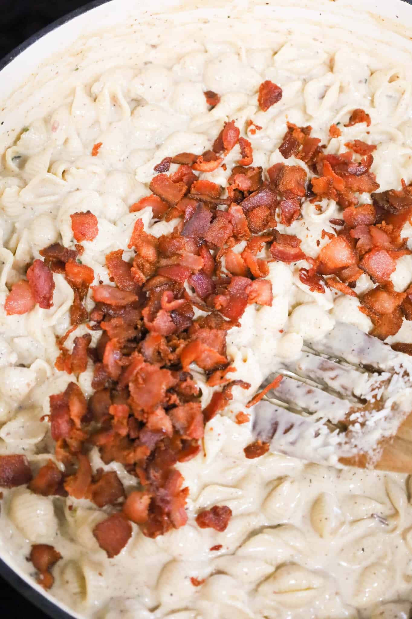 crumbled cooked bacon on top of creamy pasta