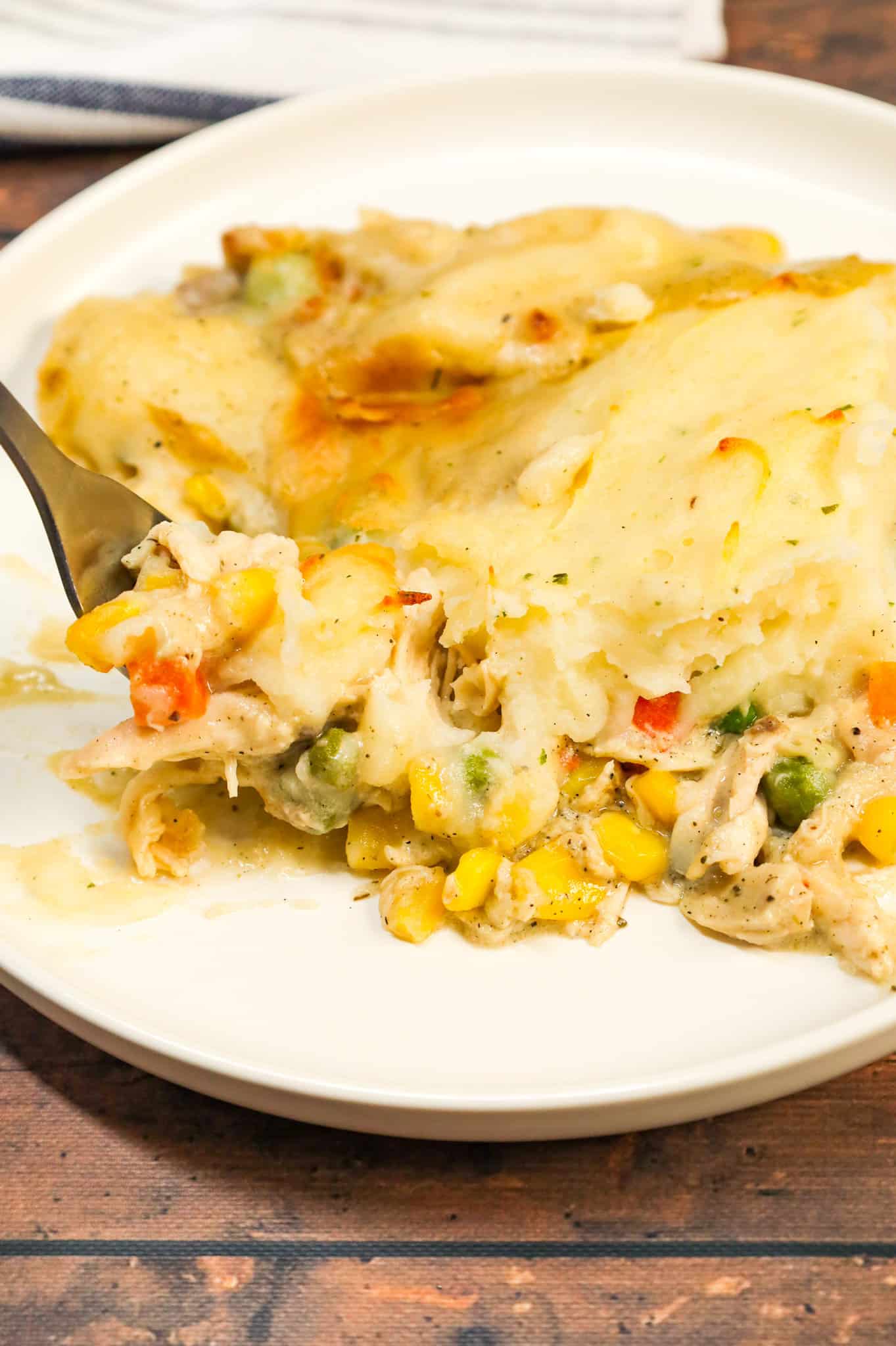 Chicken Shepherd's Pie is an easy dinner recipe loaded with shredded rotisserie chicken, mixed veggies, cream of mushroom soup and cream of chicken soup all baked with a layer of instant mashed potatoes on top.