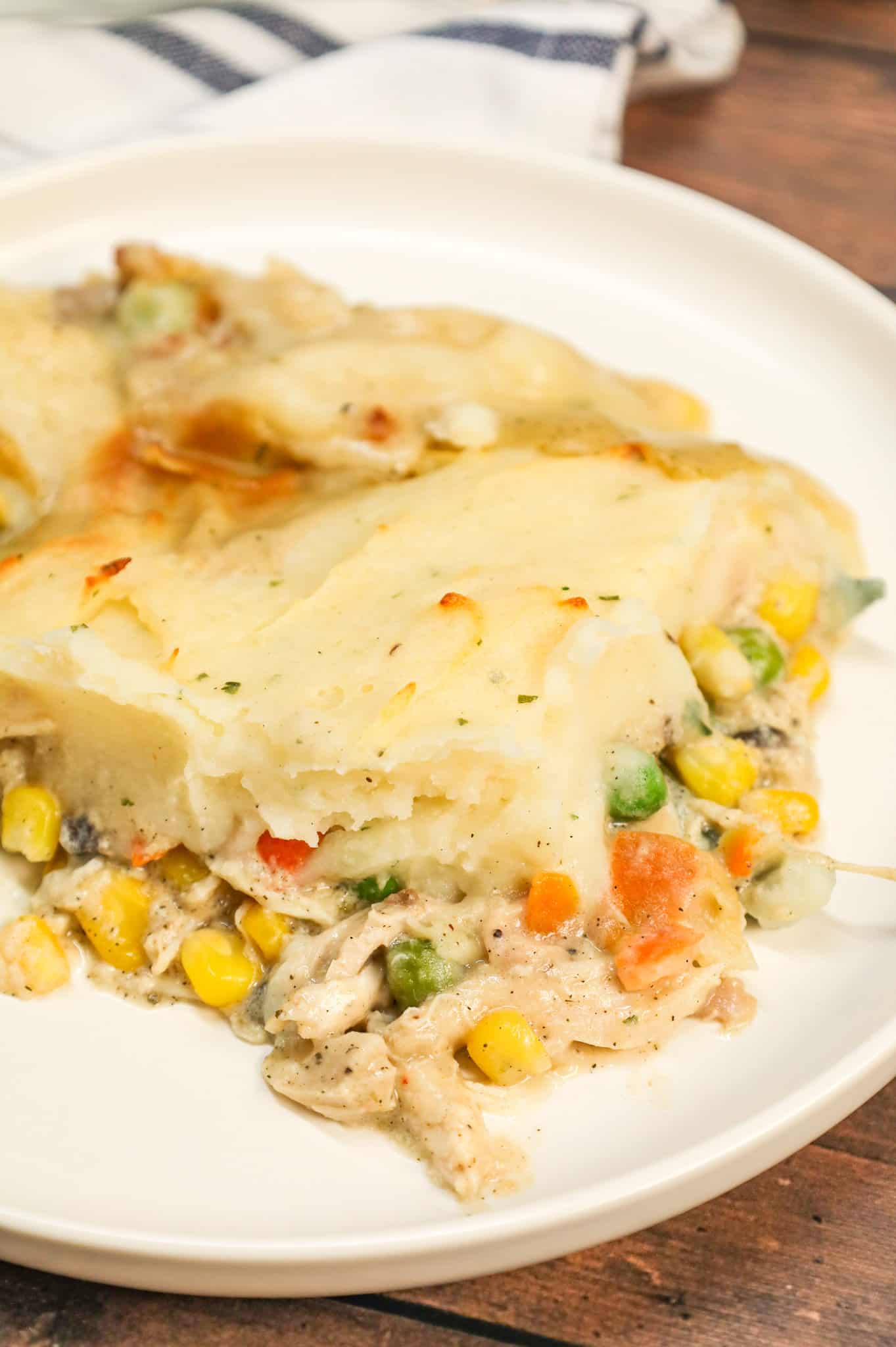 Chicken Shepherd's Pie is an easy dinner recipe loaded with shredded rotisserie chicken, mixed veggies, cream of mushroom soup and cream of chicken soup all baked with a layer of instant mashed potatoes on top.