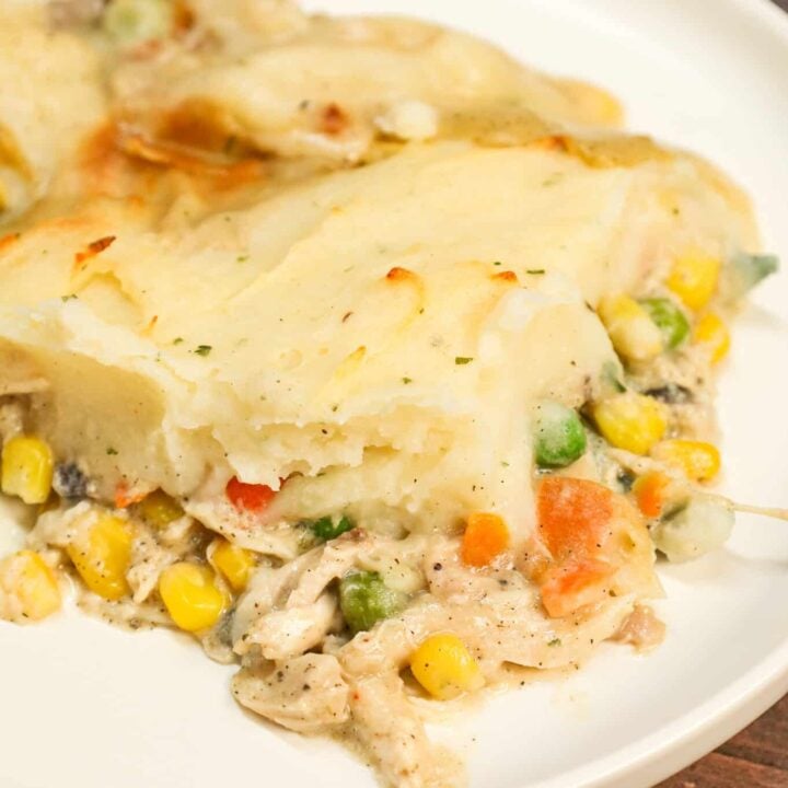 Chicken Shepherd's Pie is an easy dinner recipe loaded with shredded rotisserie chicken, mixed veggies, cream of mushroom soup and cream of chicken soup all baked with a layer of instant mashed potatoes on top.