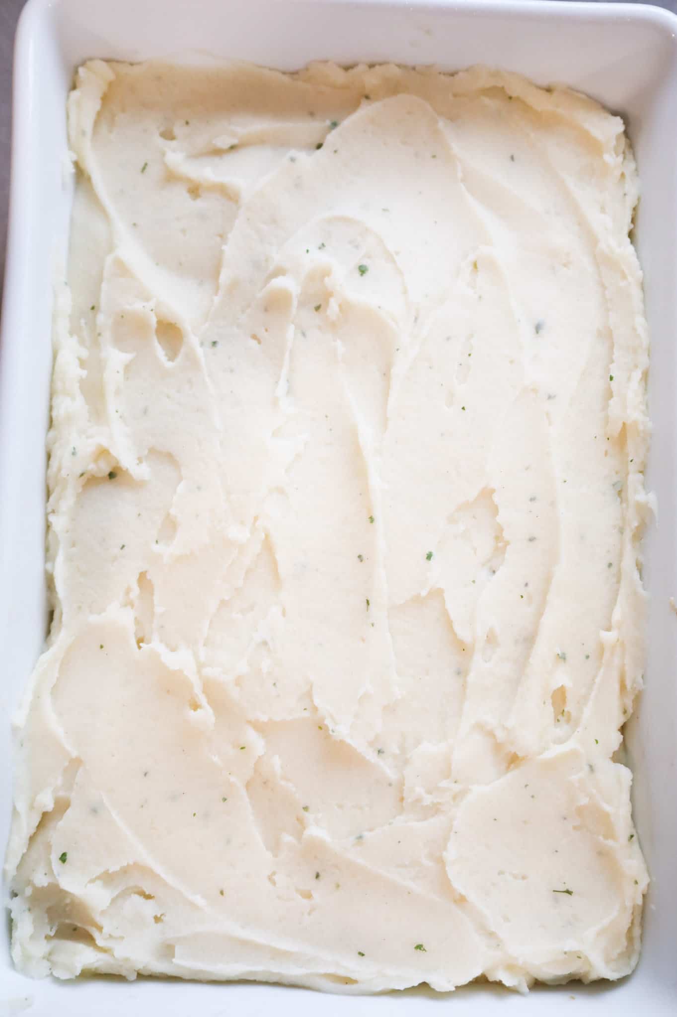 mashed potatoes spread on top of chicken shepherd's pie